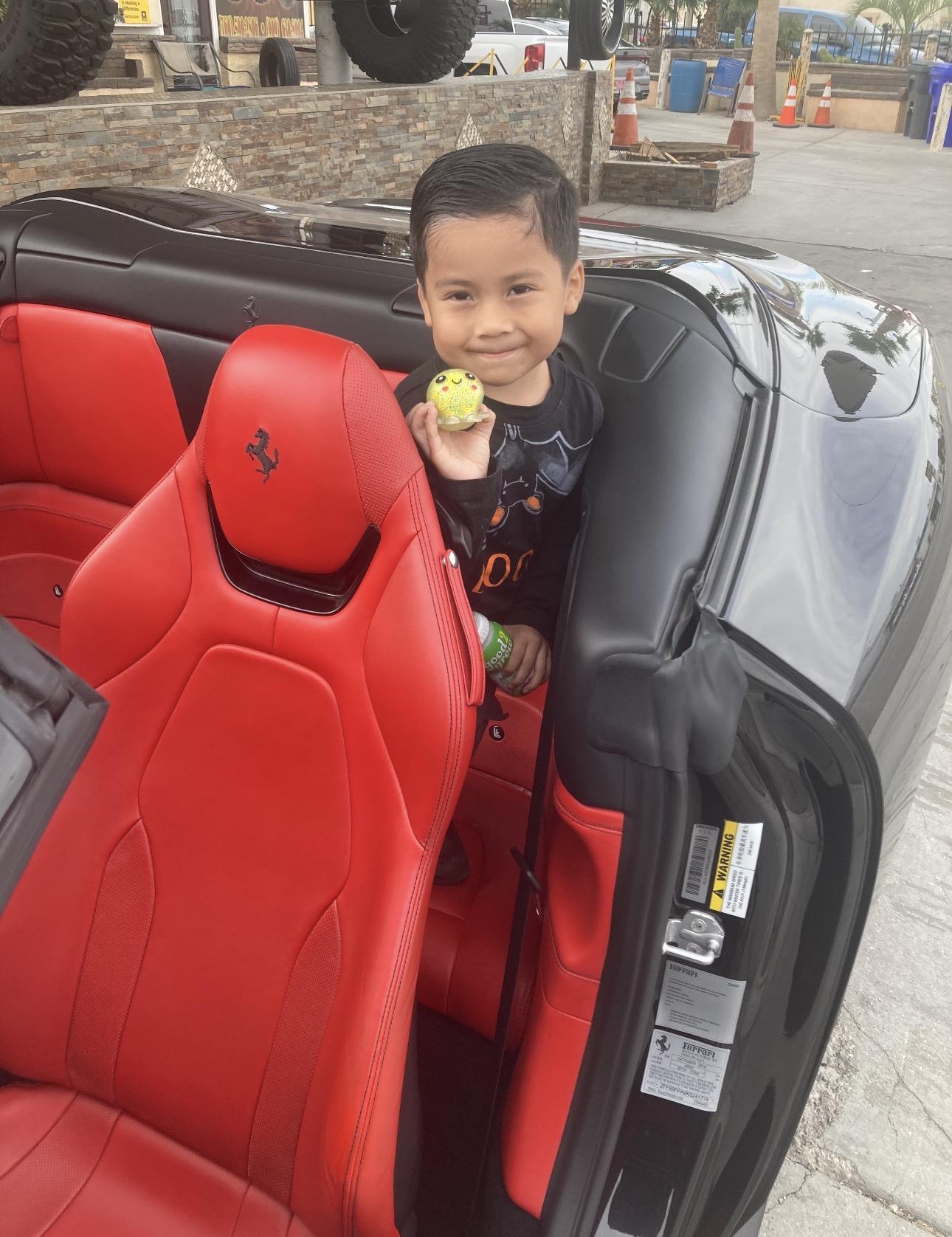 A boy sitting in a car