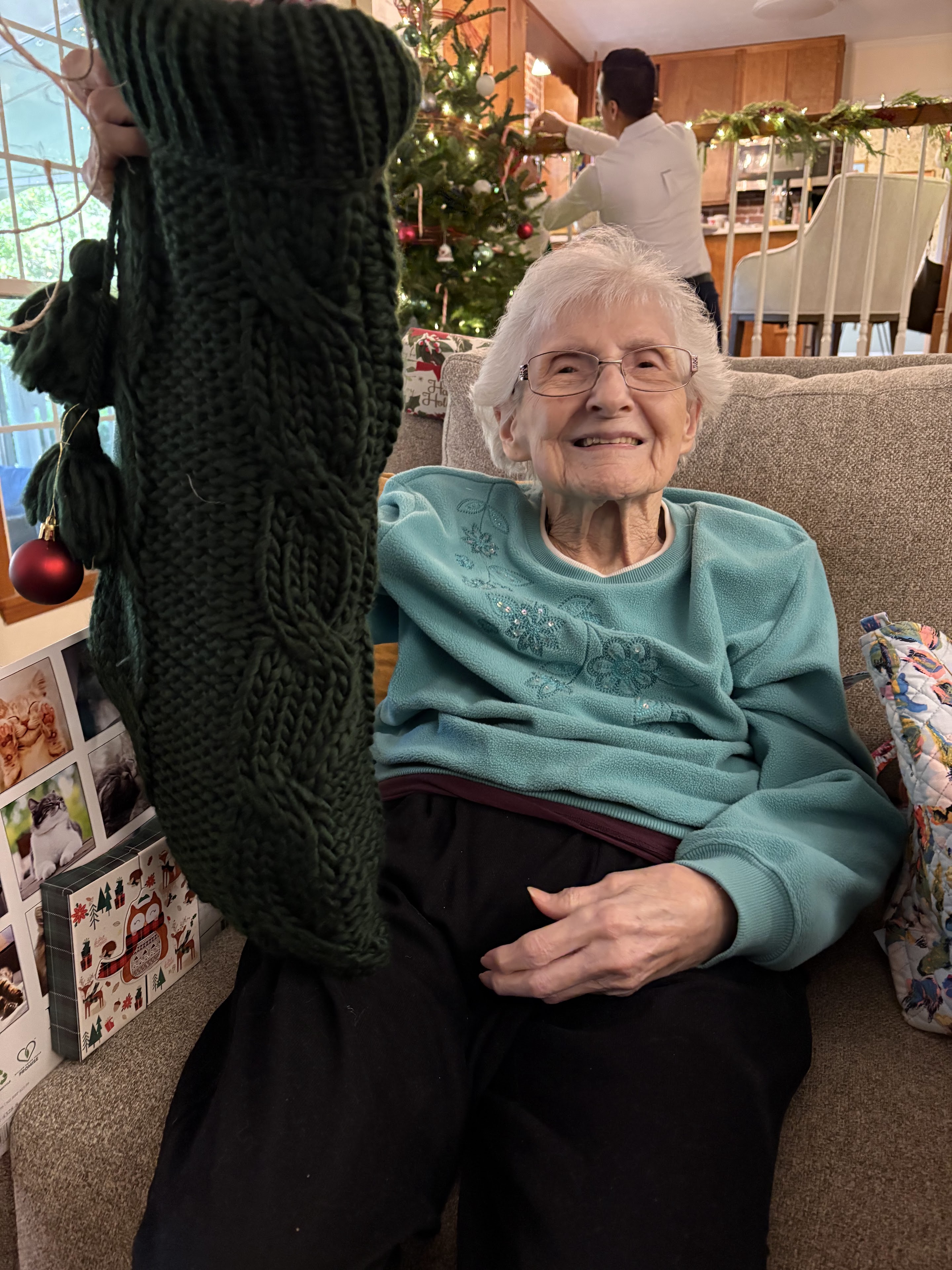 An old woman sitting on a couch