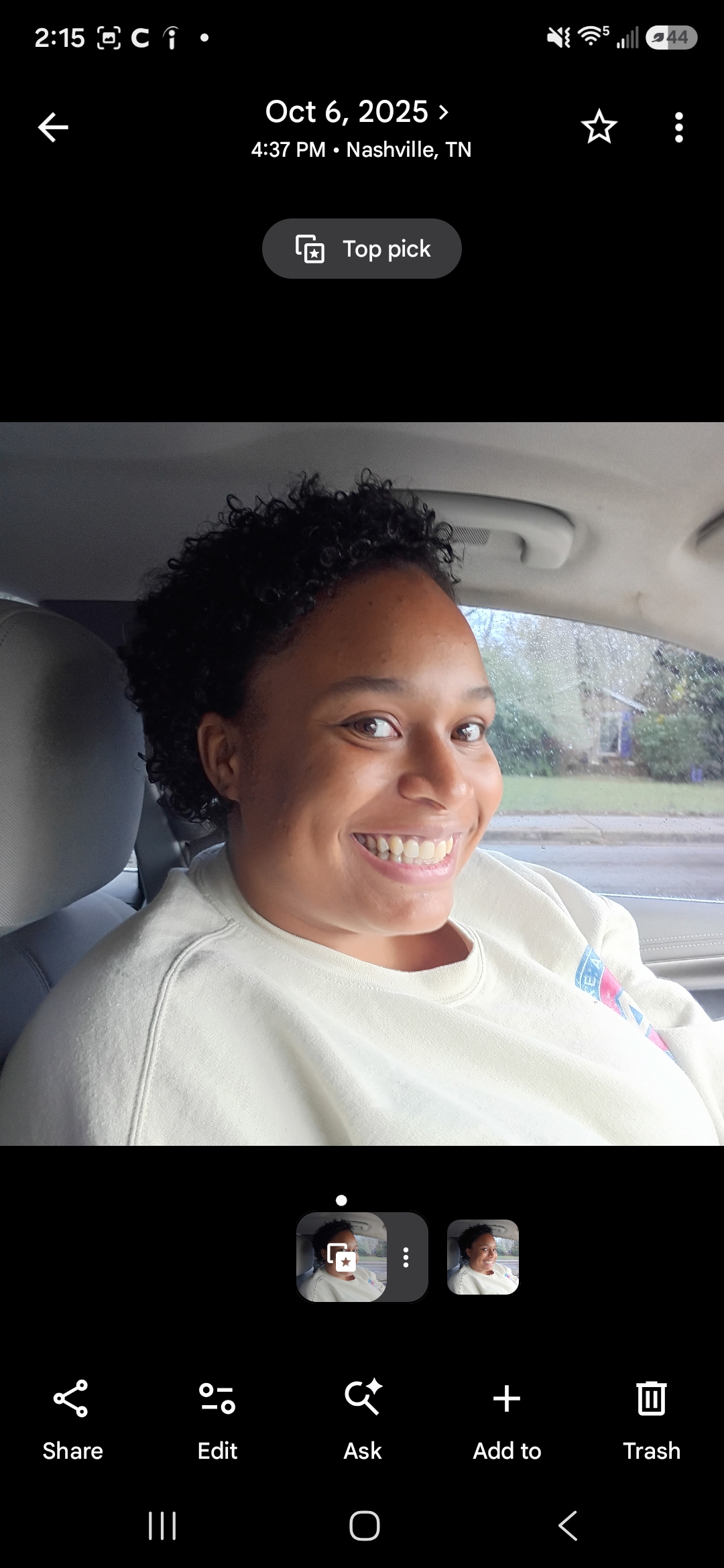 A woman smiling in a car