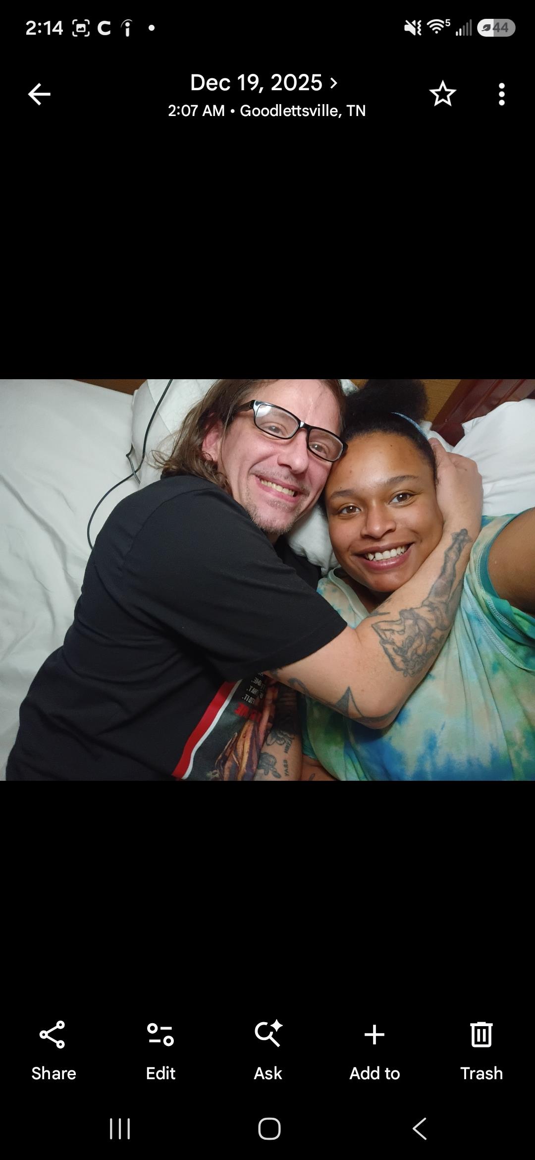 A man and woman lying on a bed