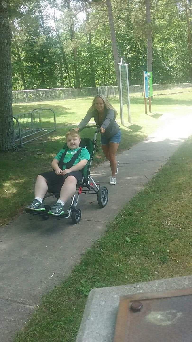 A woman pushing a child in a stroller