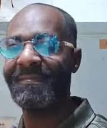 A man wearing blue glasses