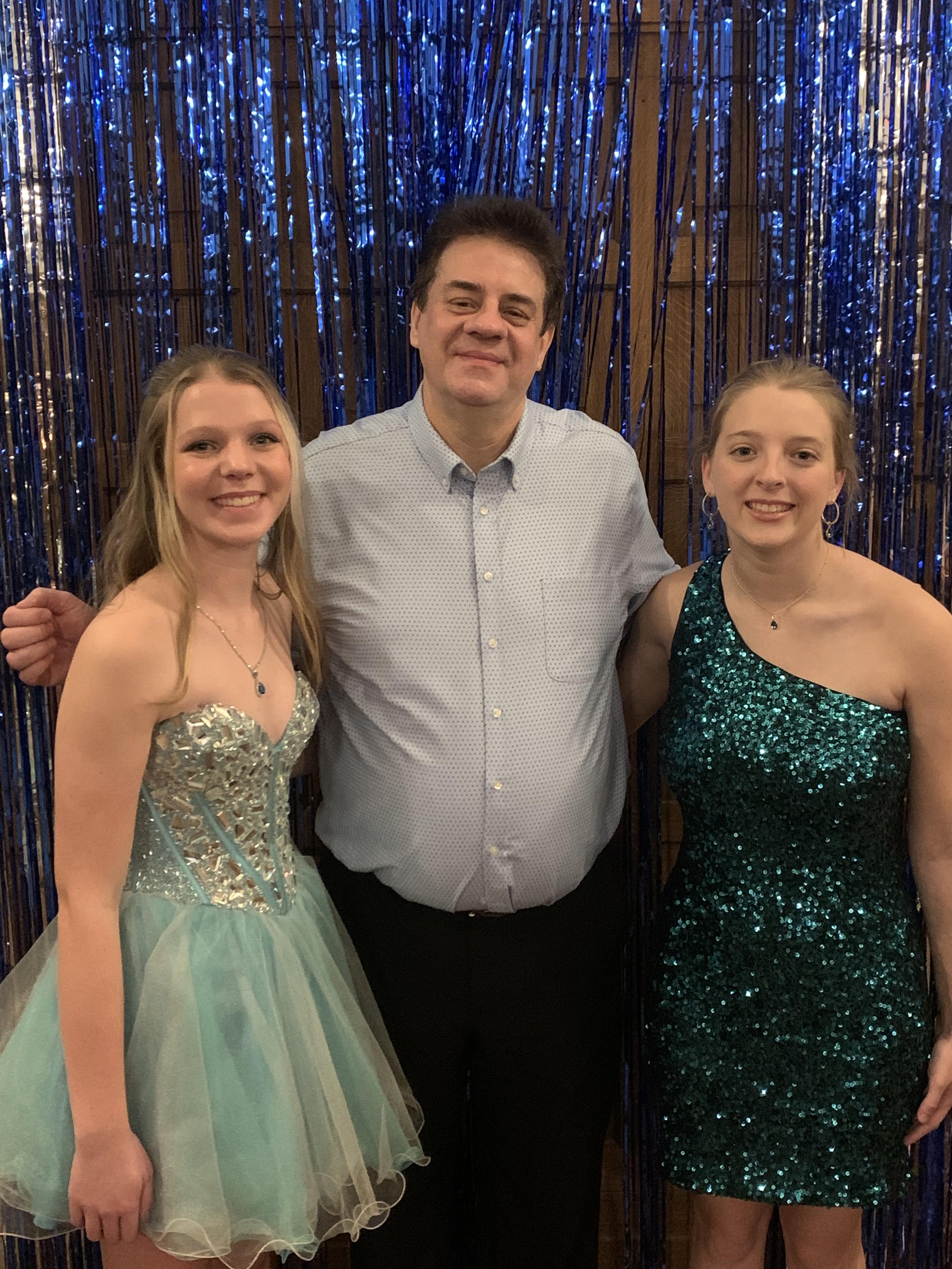 A man and two women posing for a picture