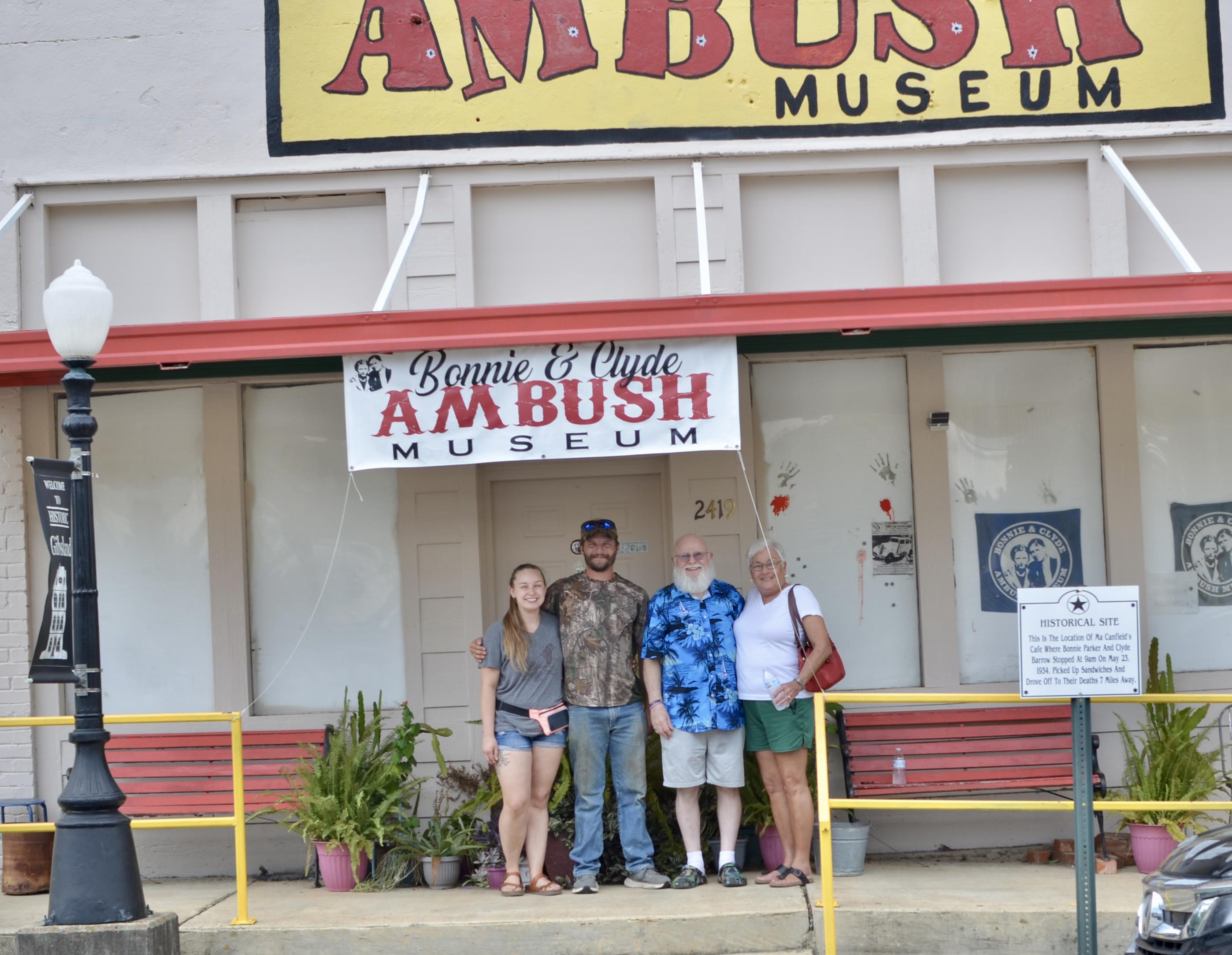 A group of people standing in front of a museum