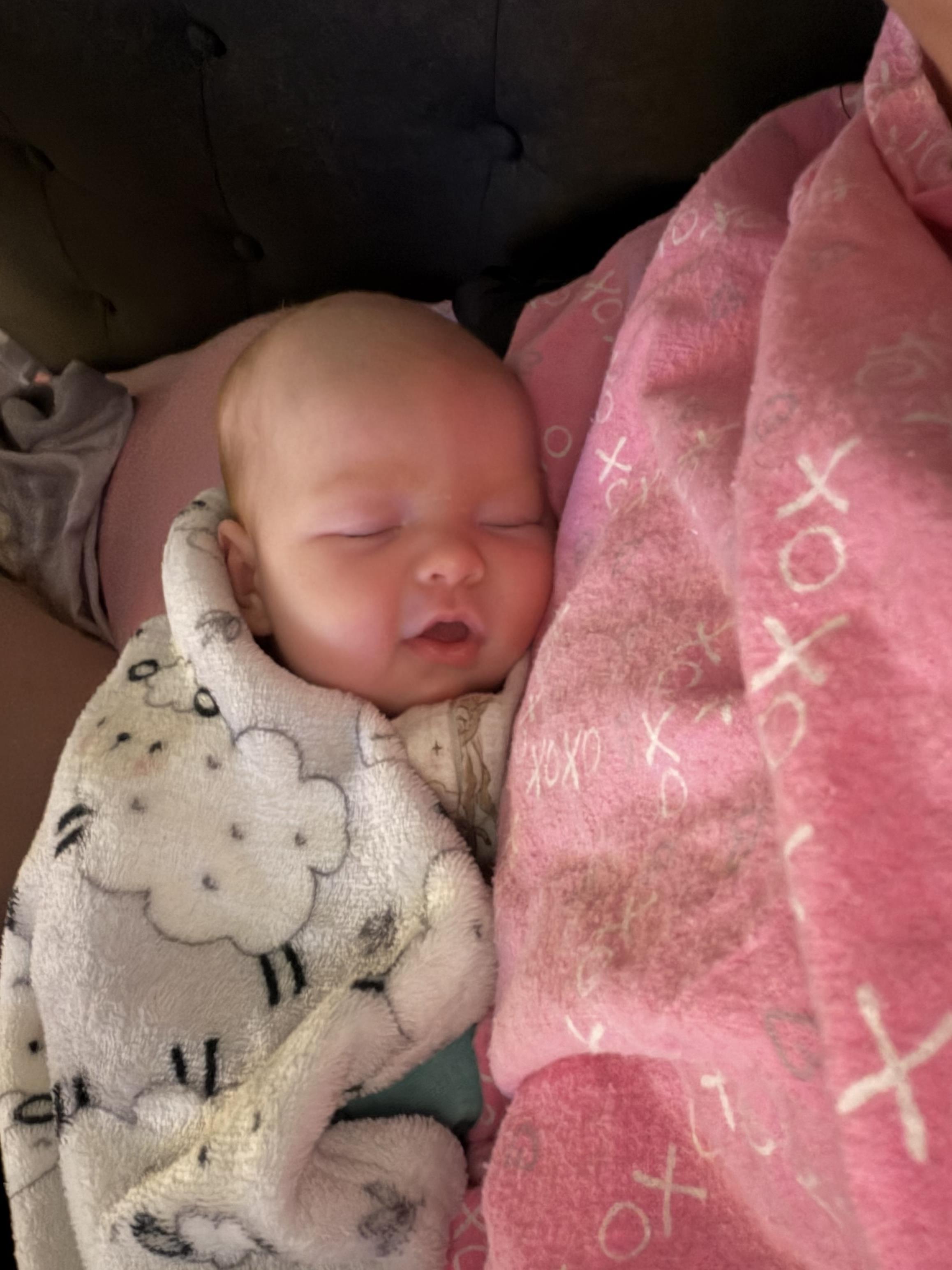A baby sleeping in a blanket