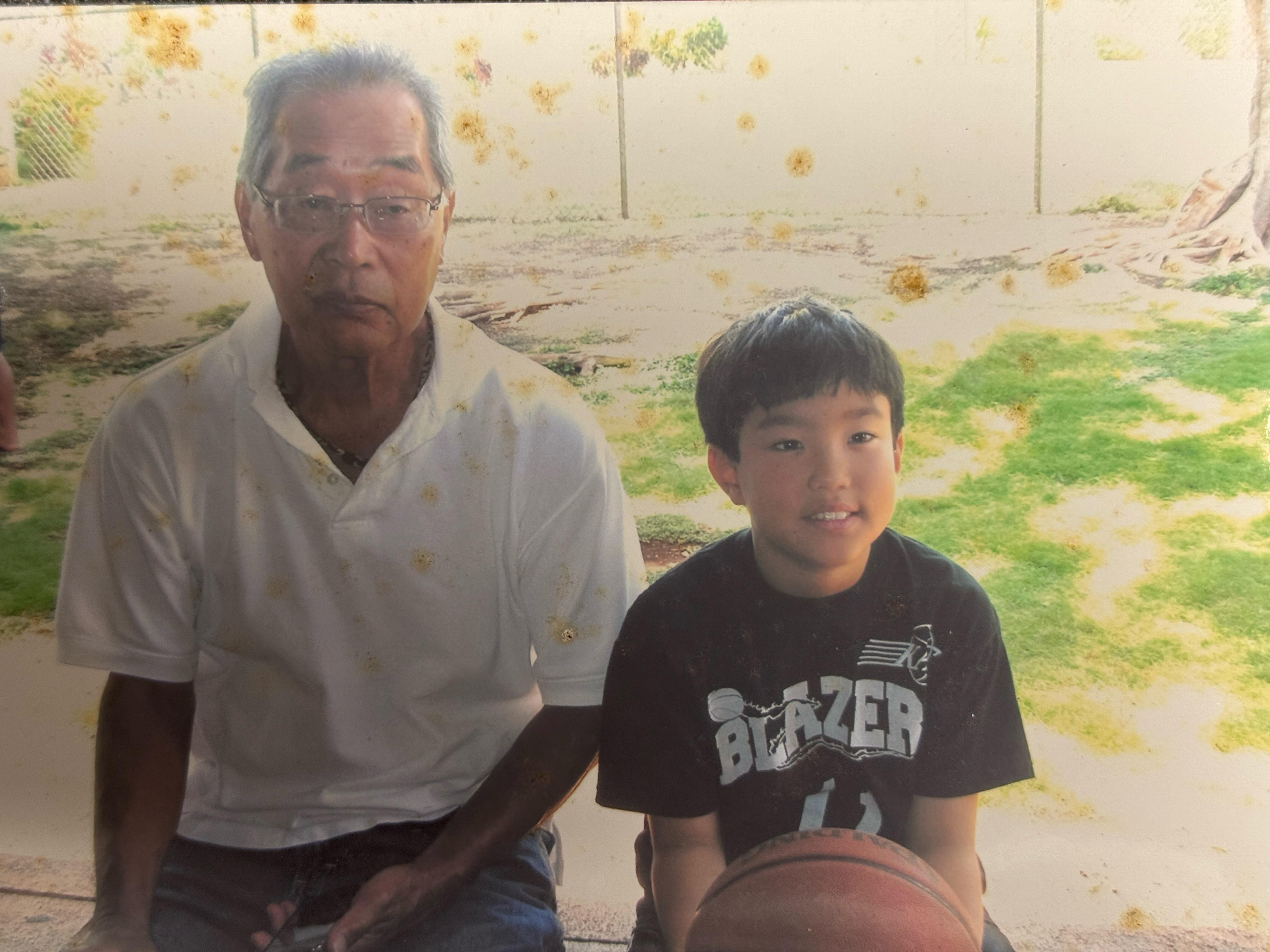 A man and boy sitting on a bench