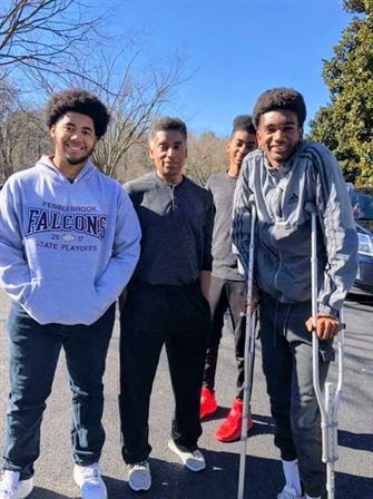 A group of men standing together with crutches