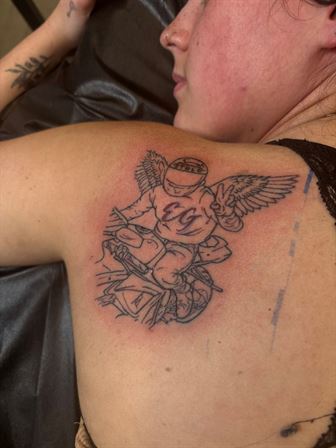 A person's back with a tattoo