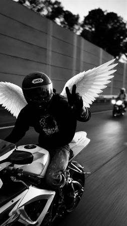 A man riding a motorcycle with wings