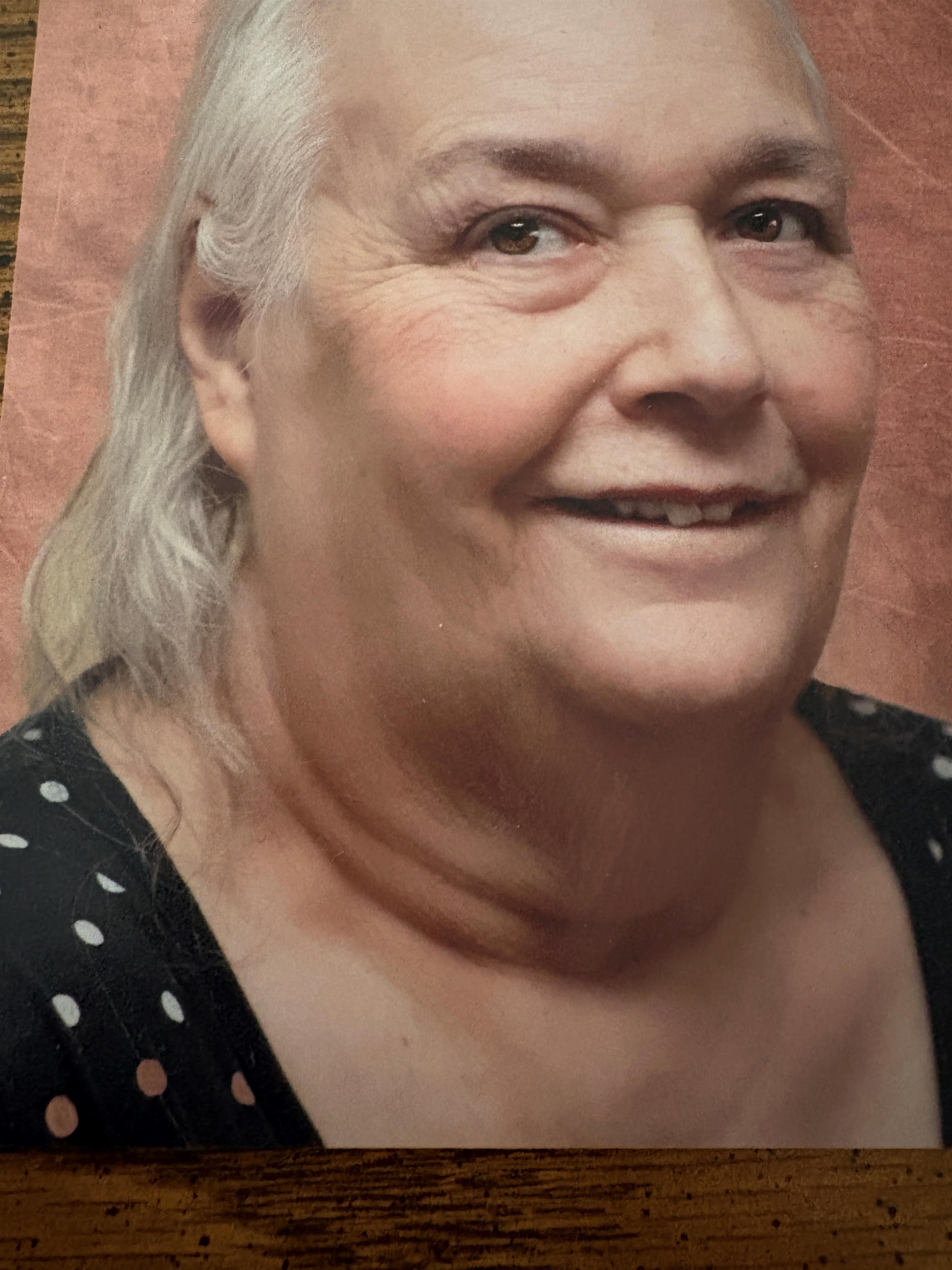 A woman with white hair and a black shirt