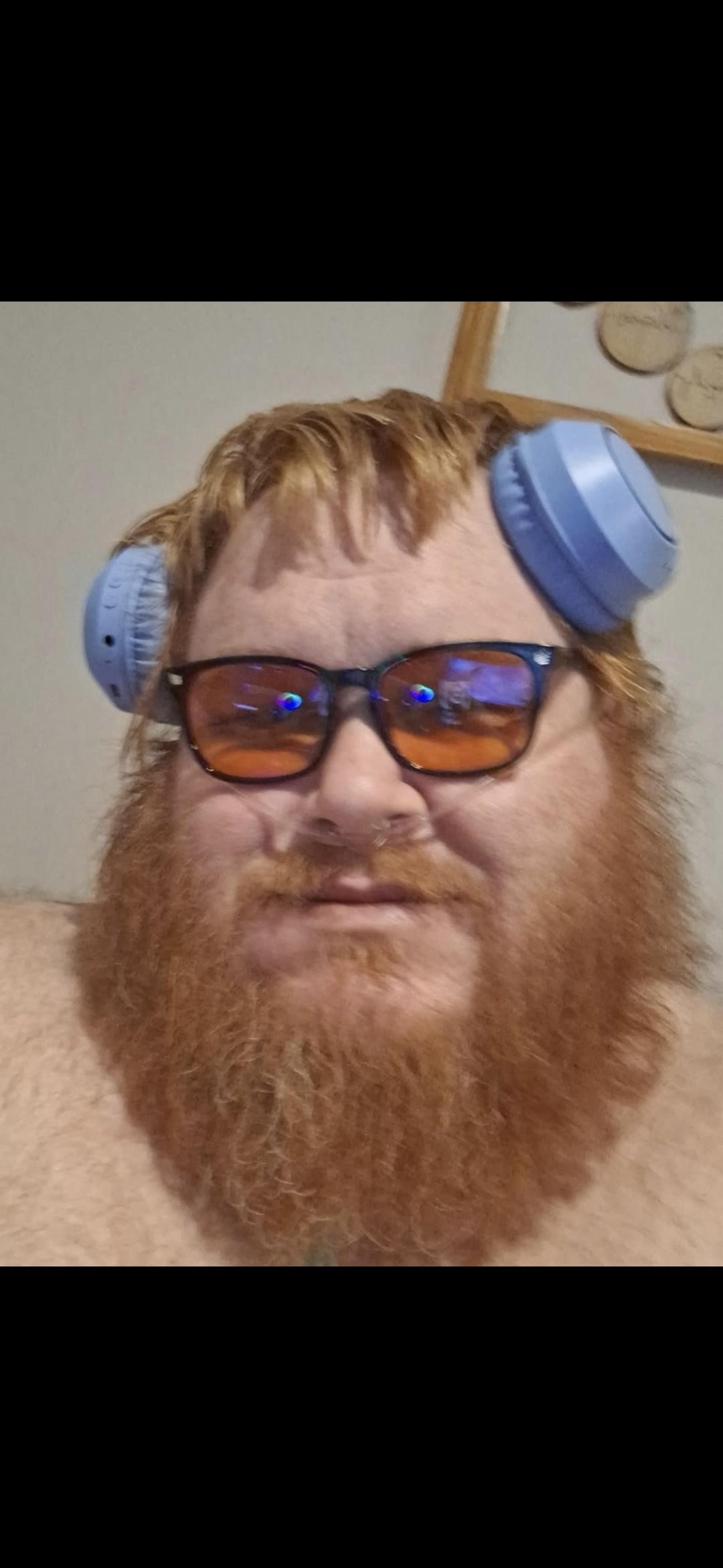 A man with a beard and glasses