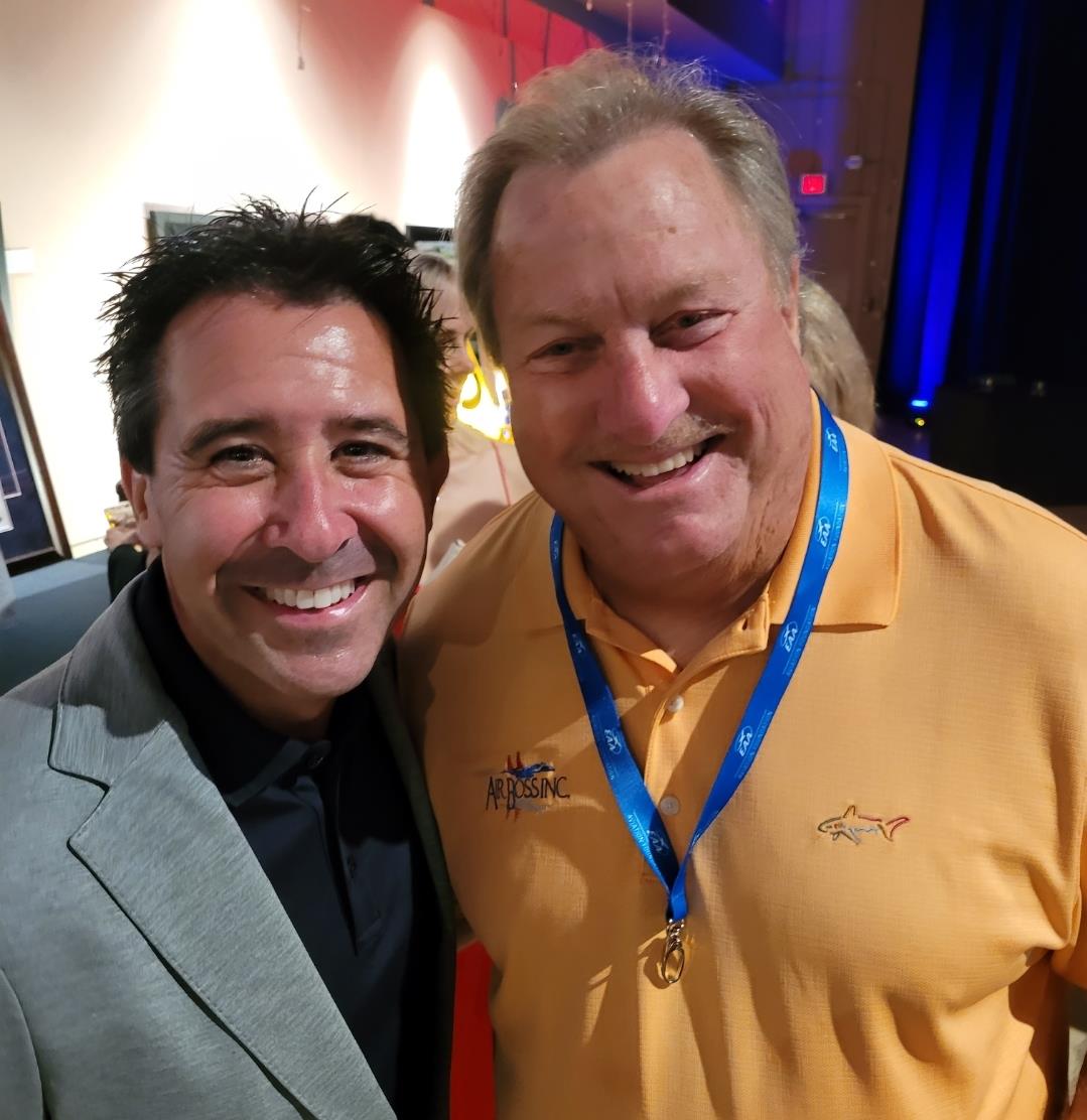 Two men smiling at the camera