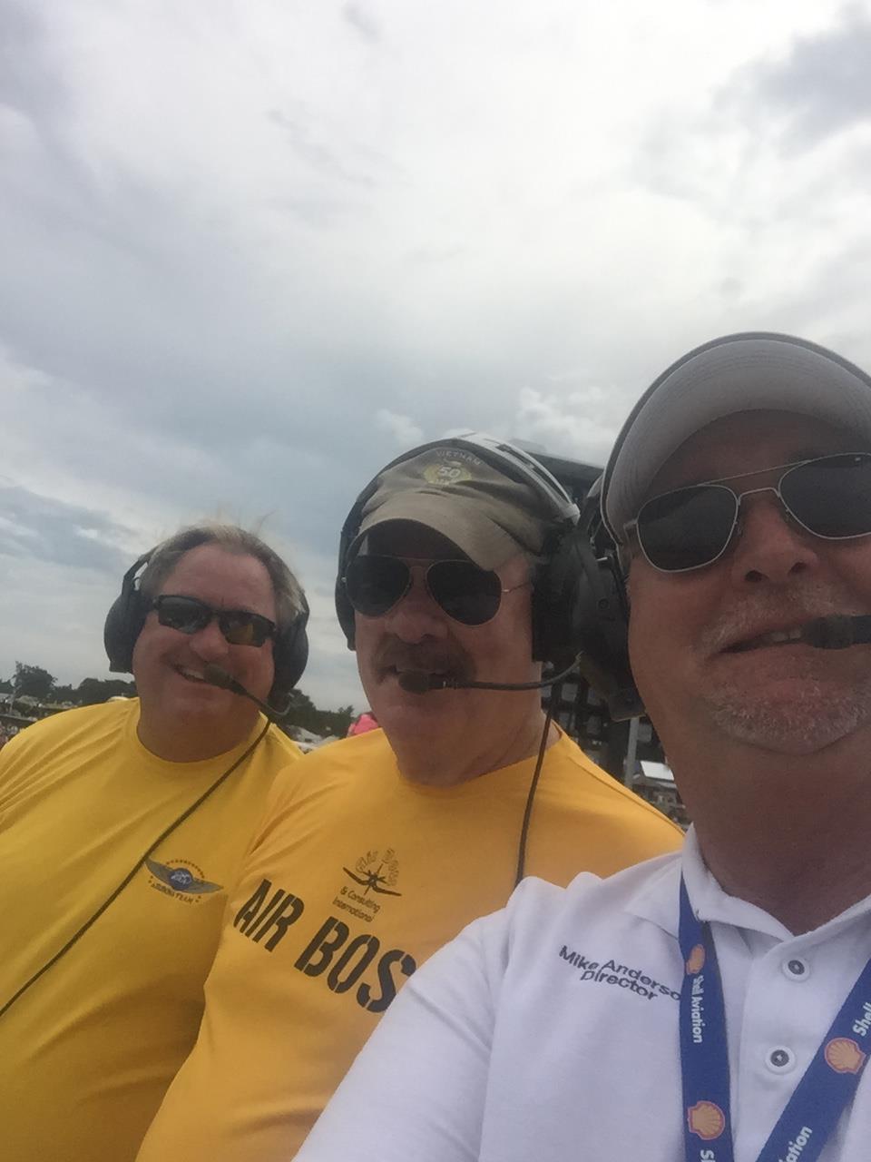 A group of men wearing sunglasses and headsets