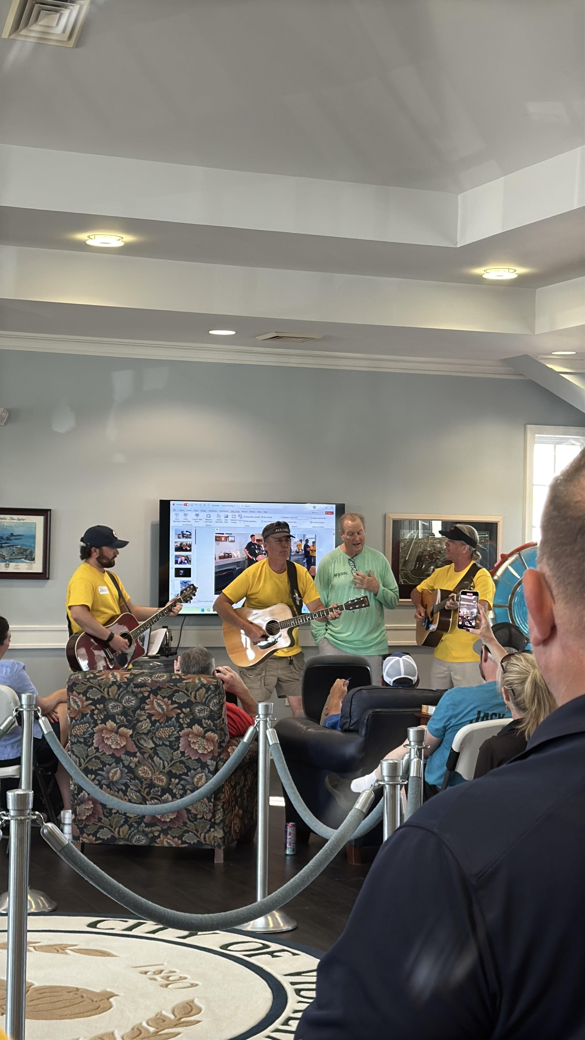 A group of men playing guitars in a room