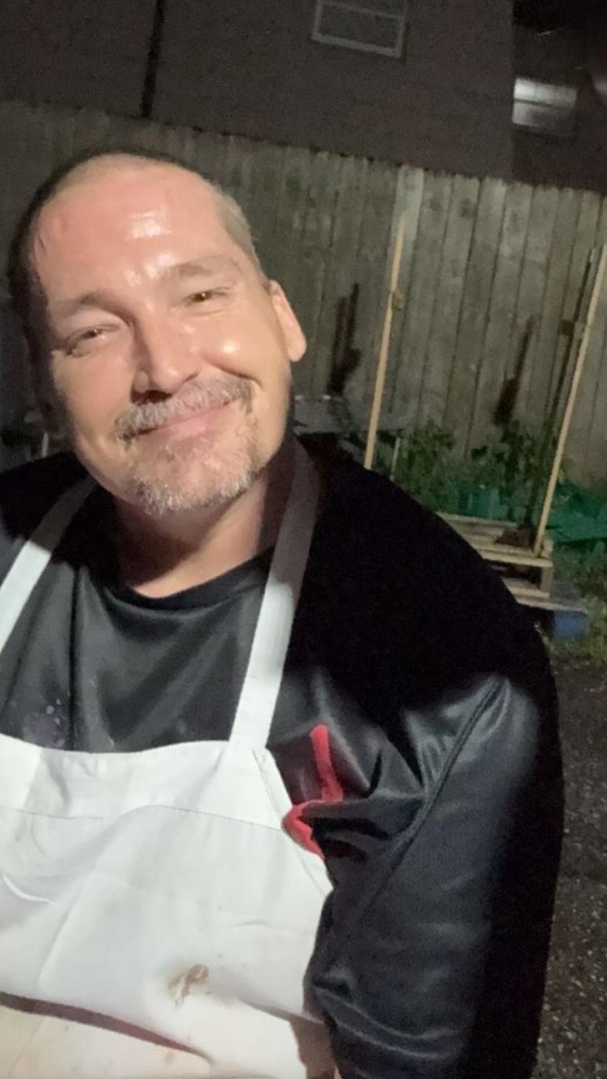 A man wearing a white apron