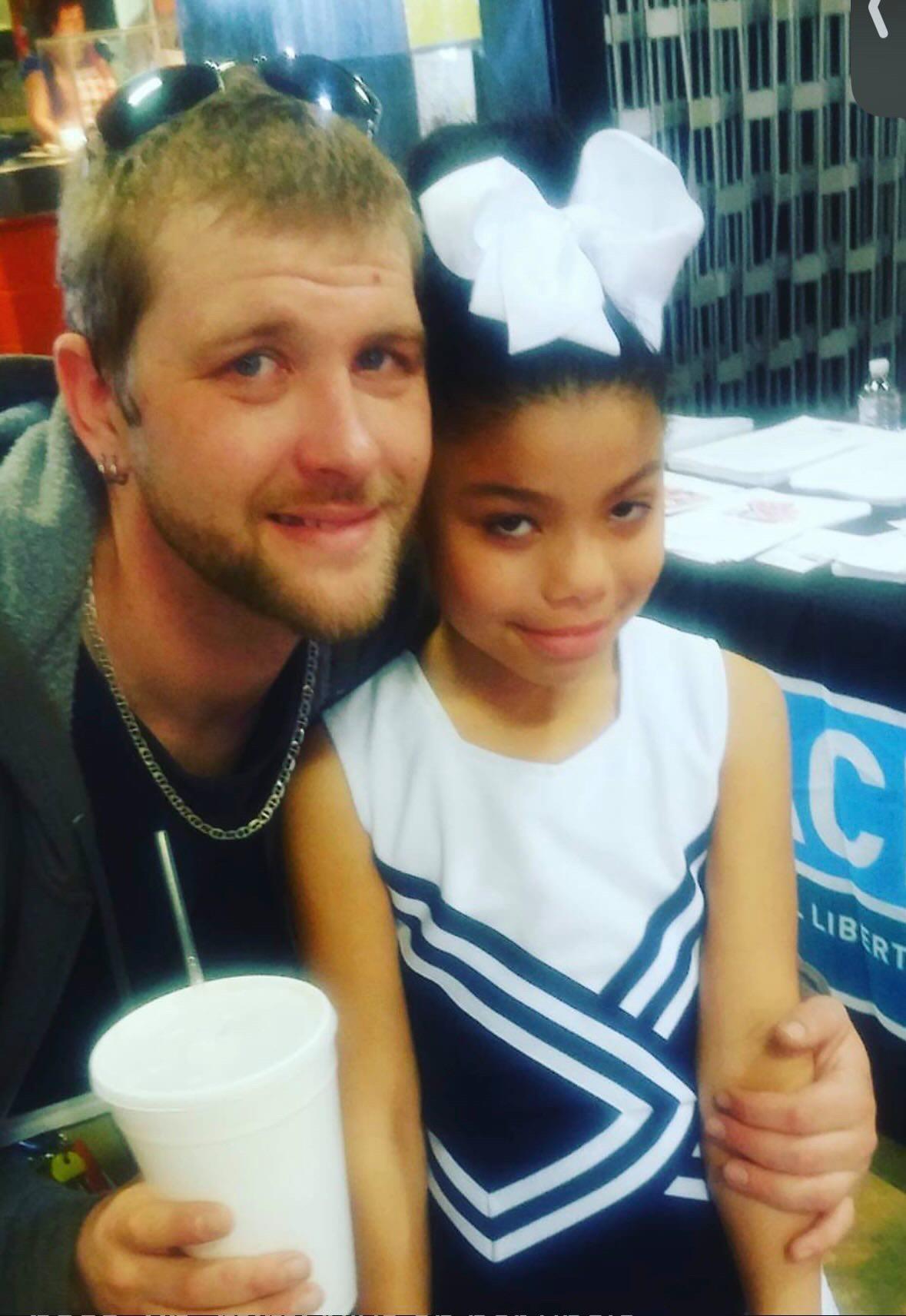 A man and a girl posing for a picture