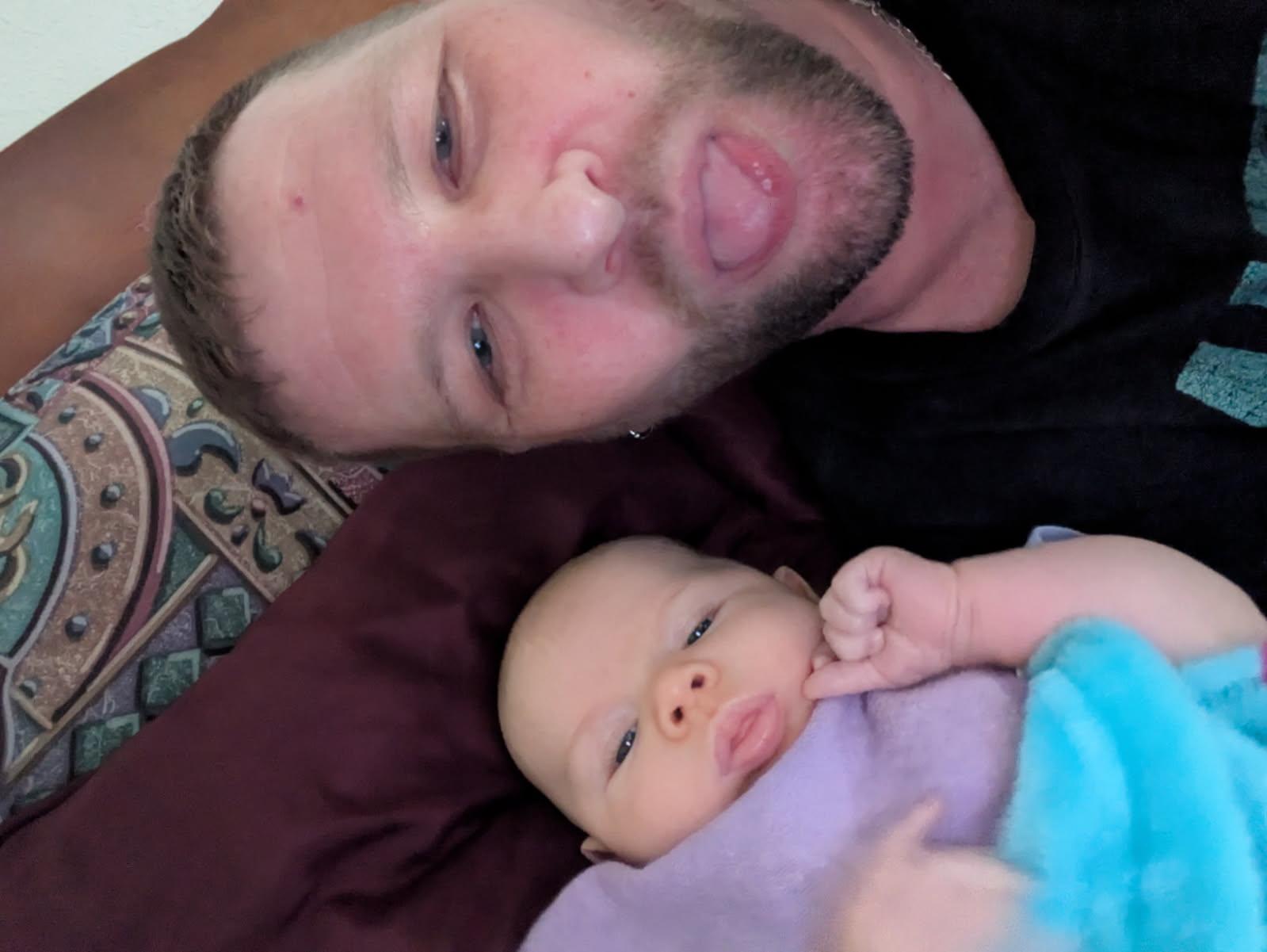 A man taking a selfie with a baby