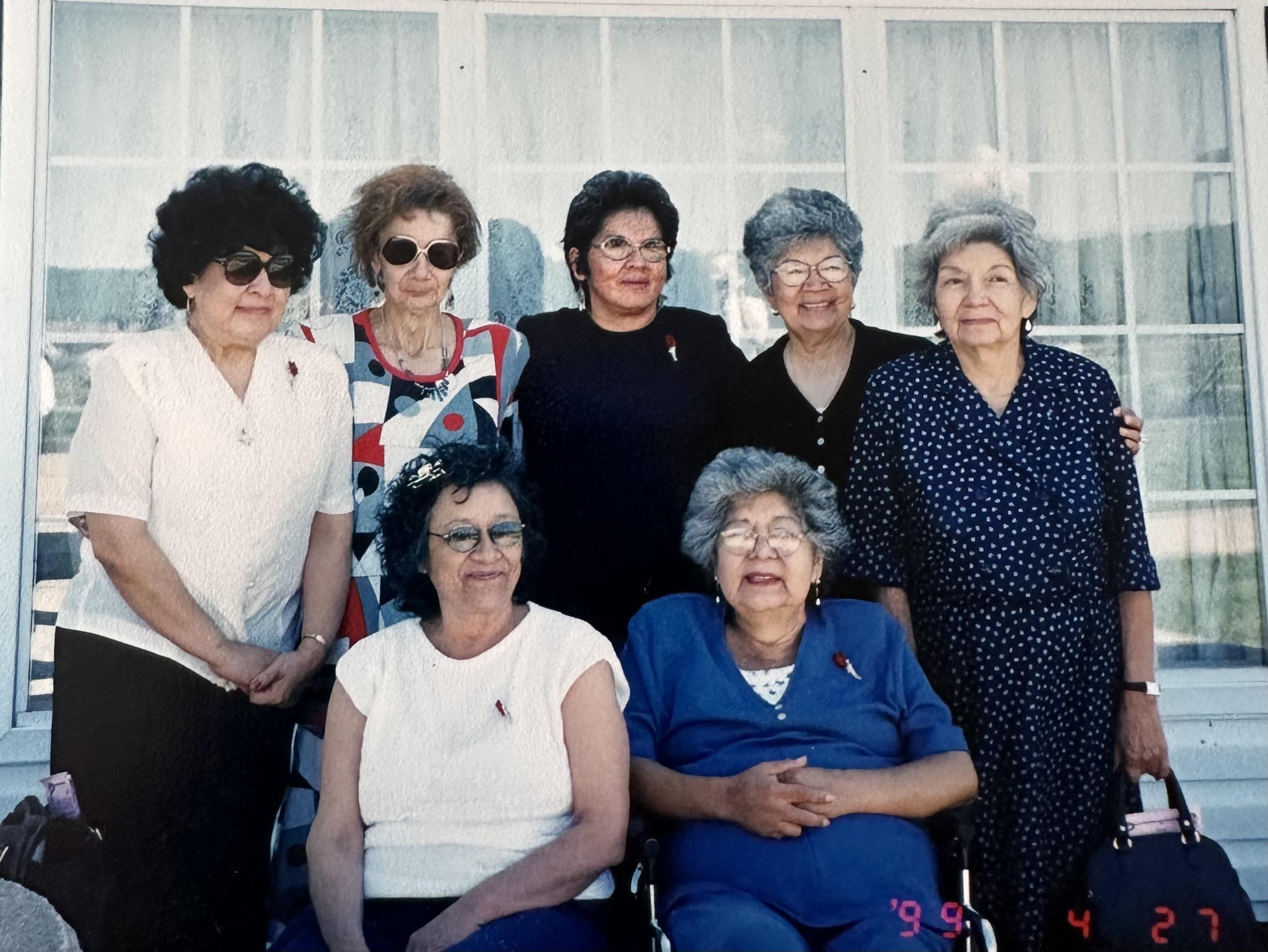 A group of older women posing for a photo