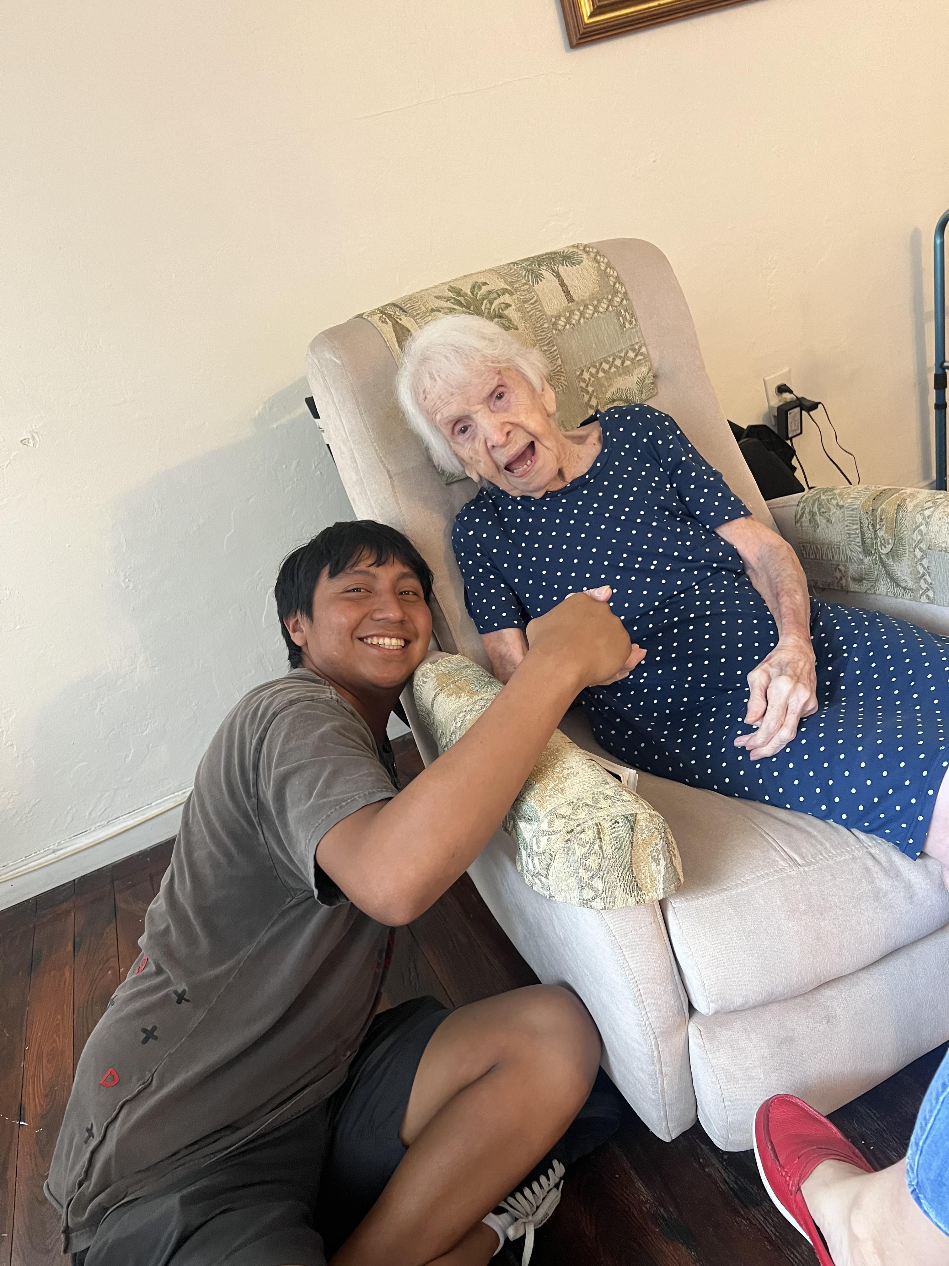 A man and an old woman sitting in a chair