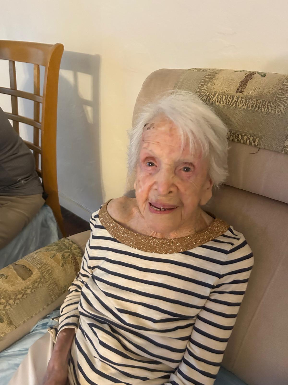 An old woman sitting on a chair