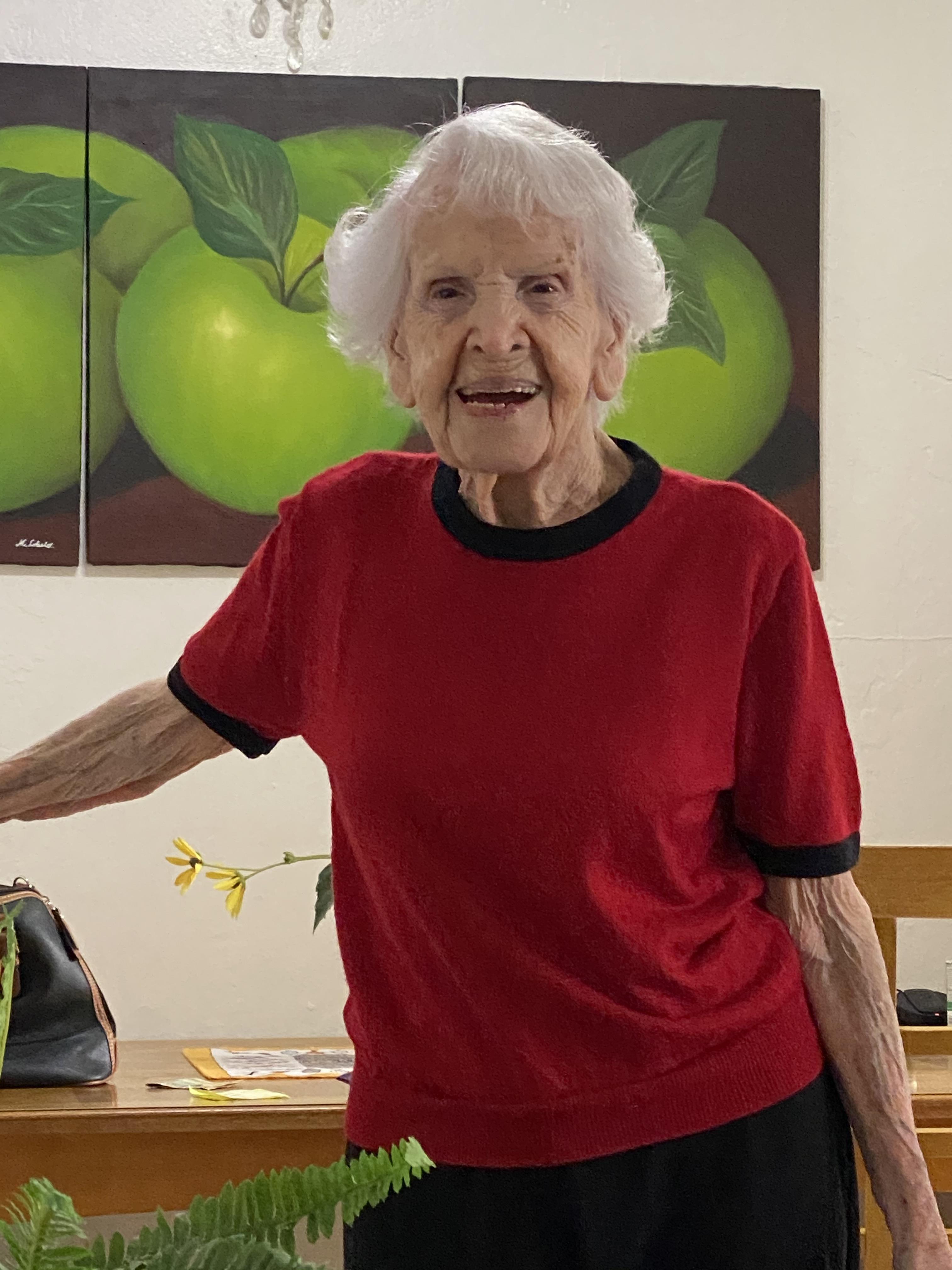 An older woman in a red shirt