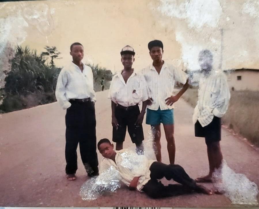 A group of men standing on a road