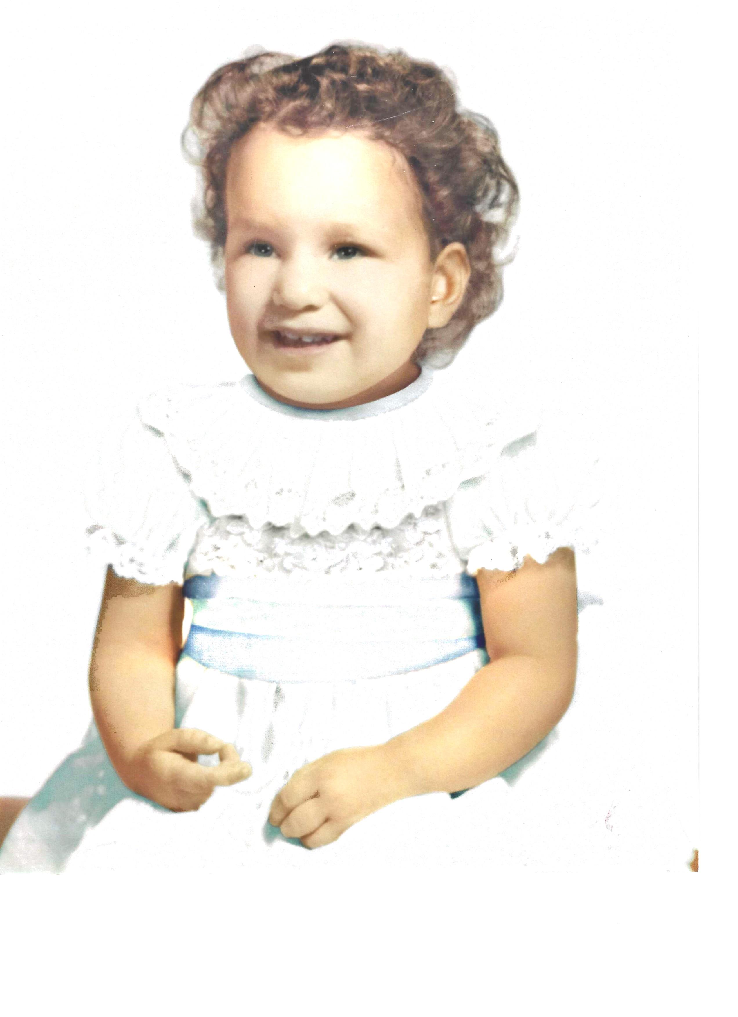 A baby in a white dress