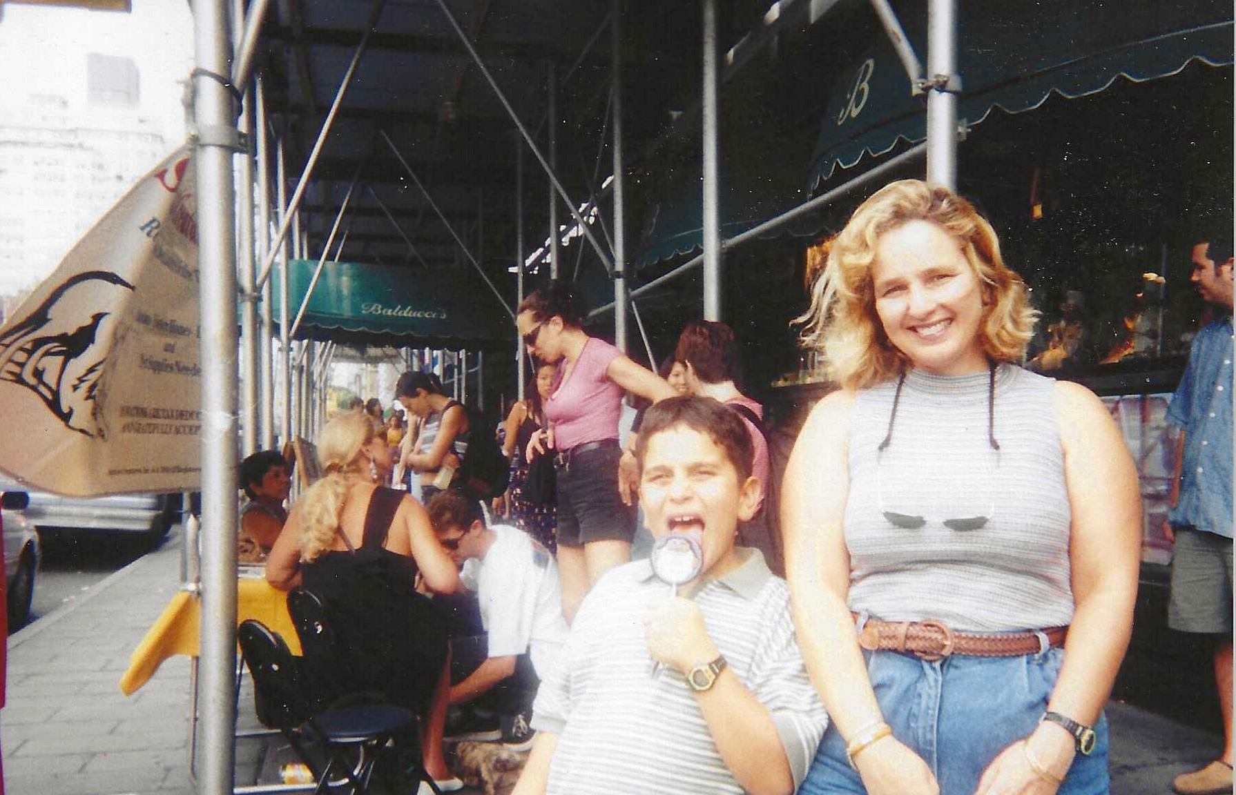 A woman and a boy eating outside