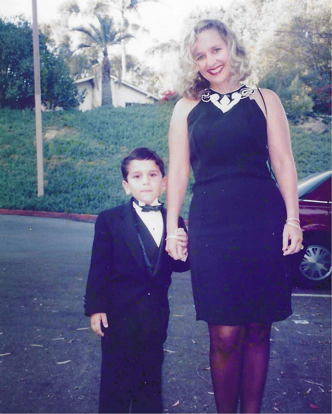 A woman and a boy posing for a picture