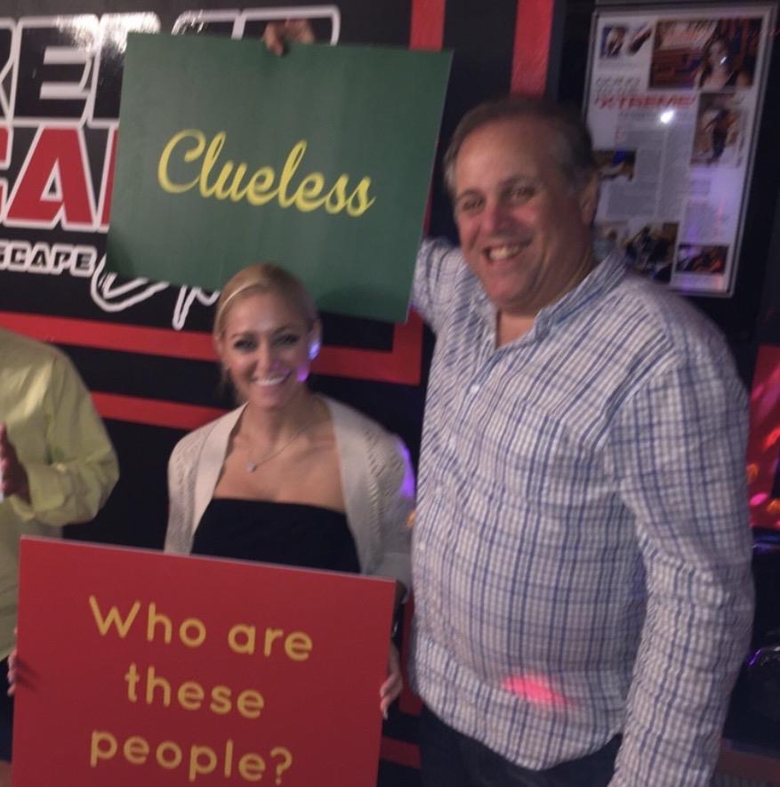 A man and woman holding signs