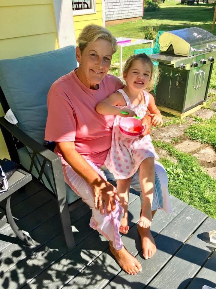 A woman and a child sitting on a chair