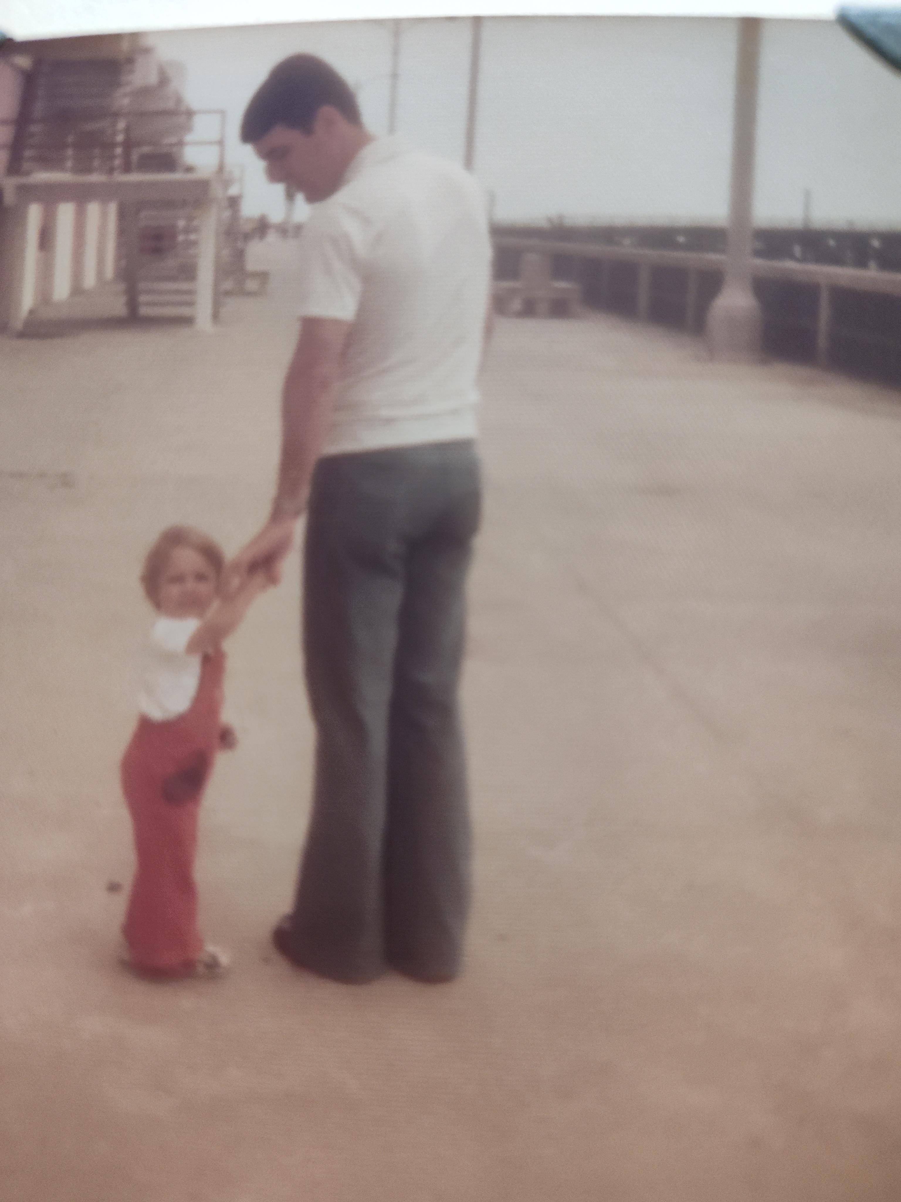 A man holding a child's hand