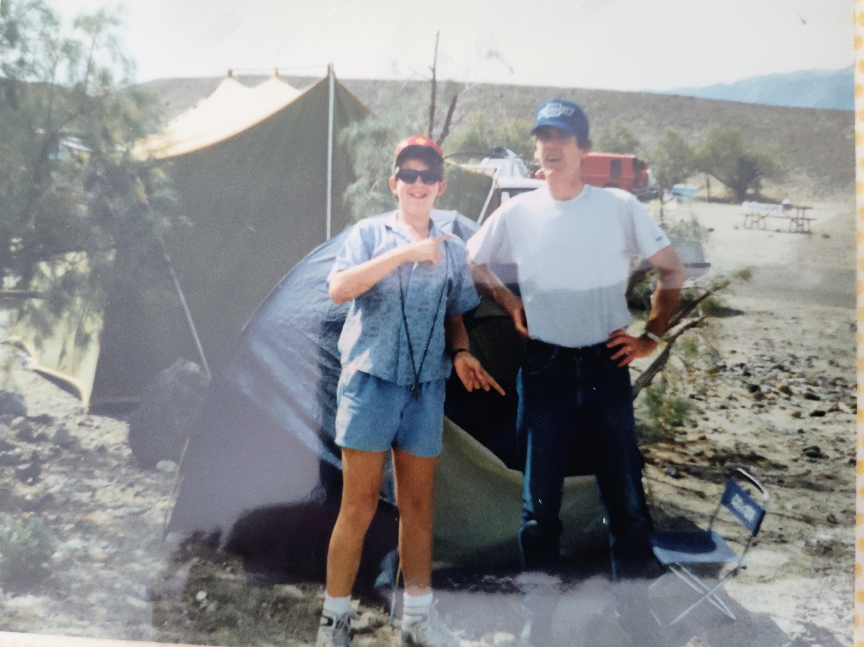 A man and woman standing in front of a tent