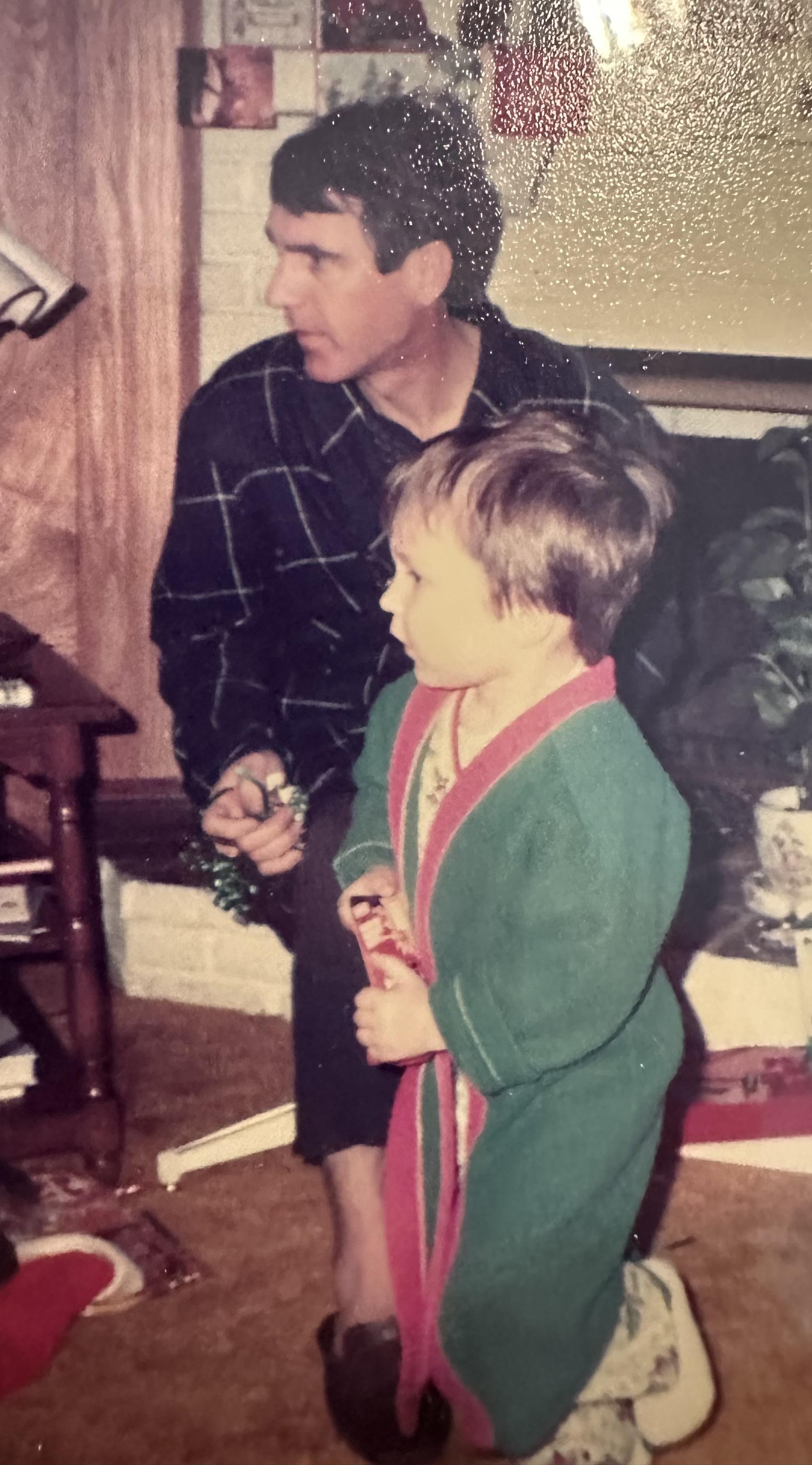 A man and child standing in a room
