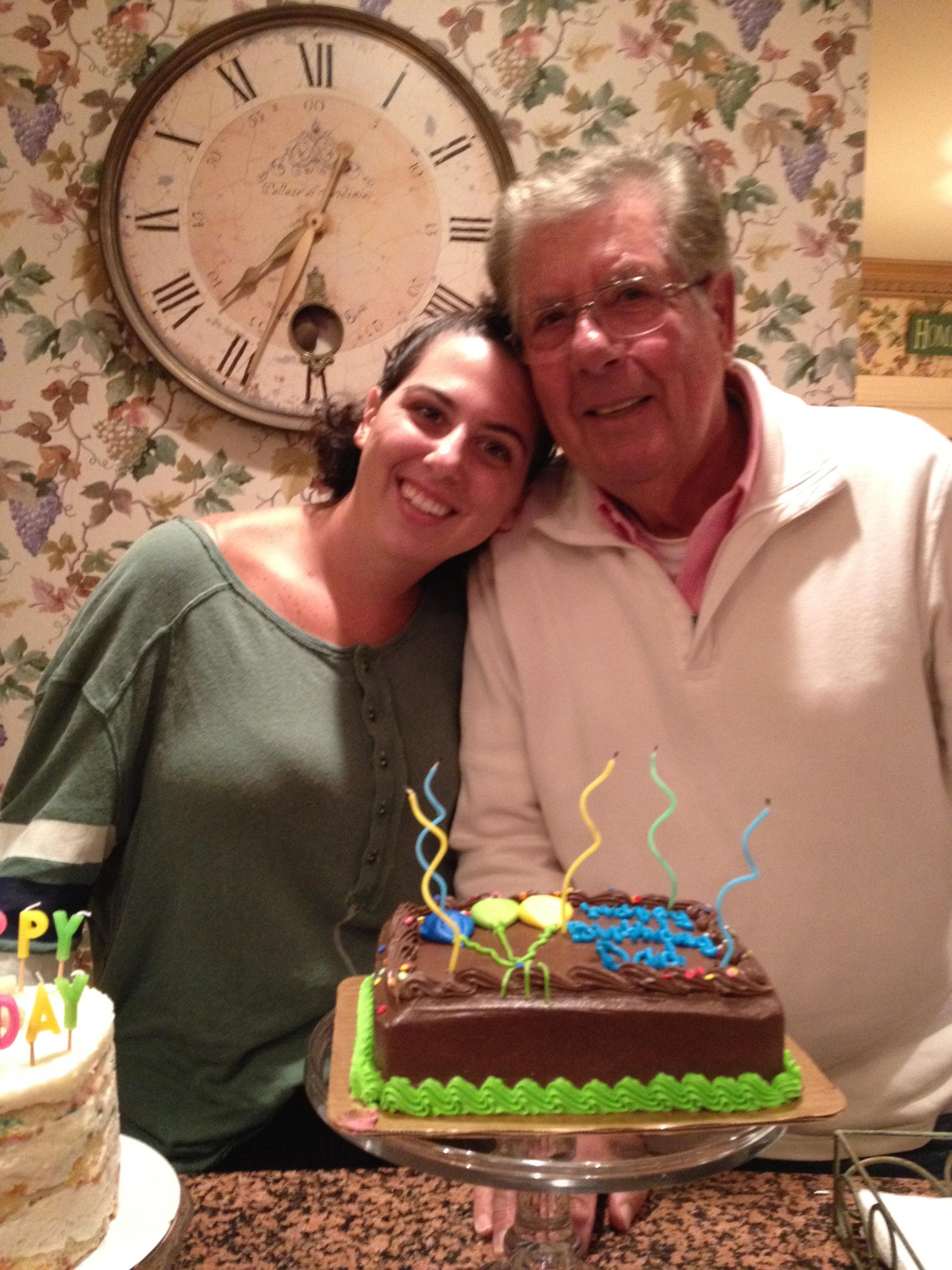 A man and woman posing with a cake