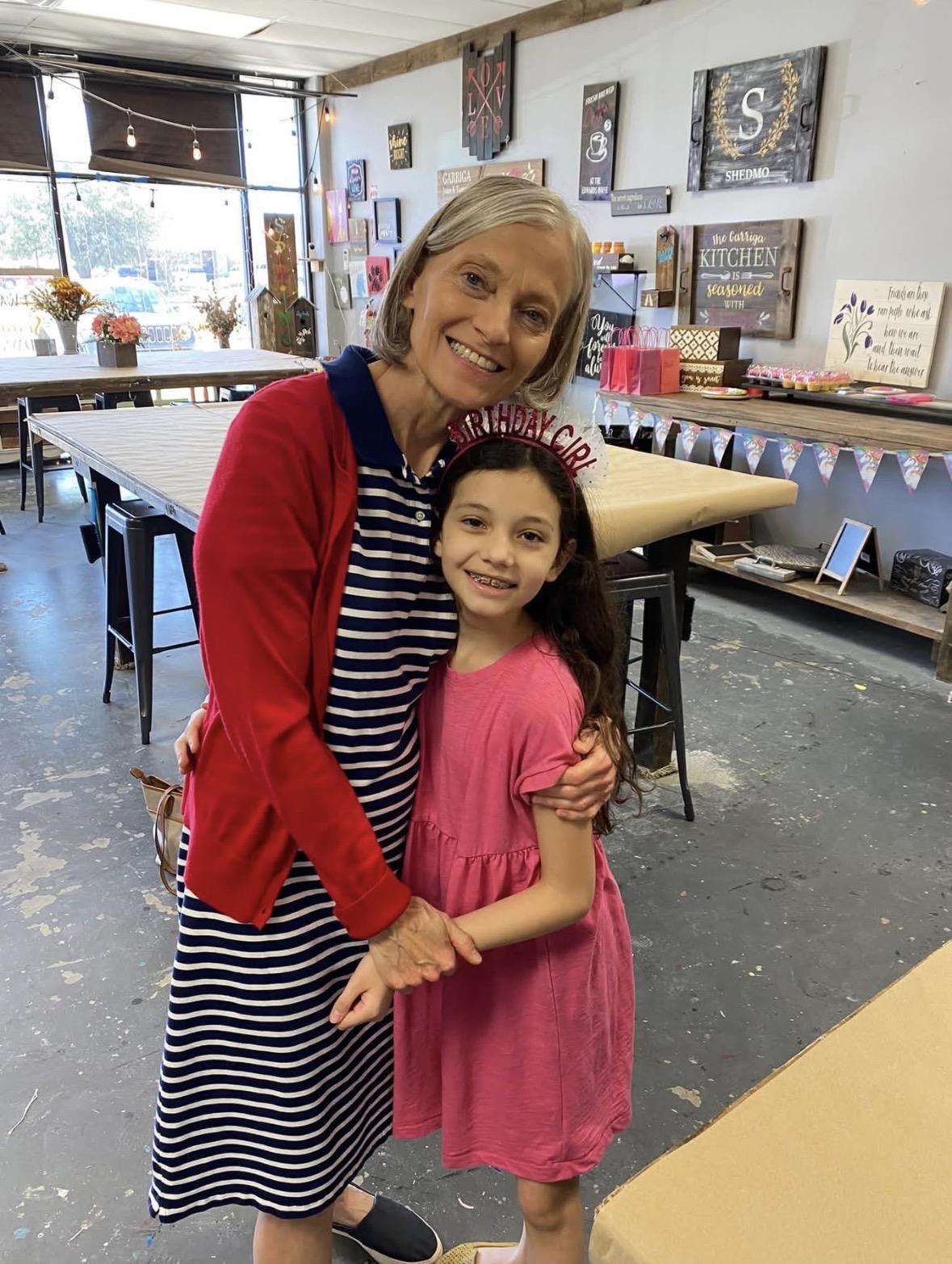 A woman and a girl posing for a picture