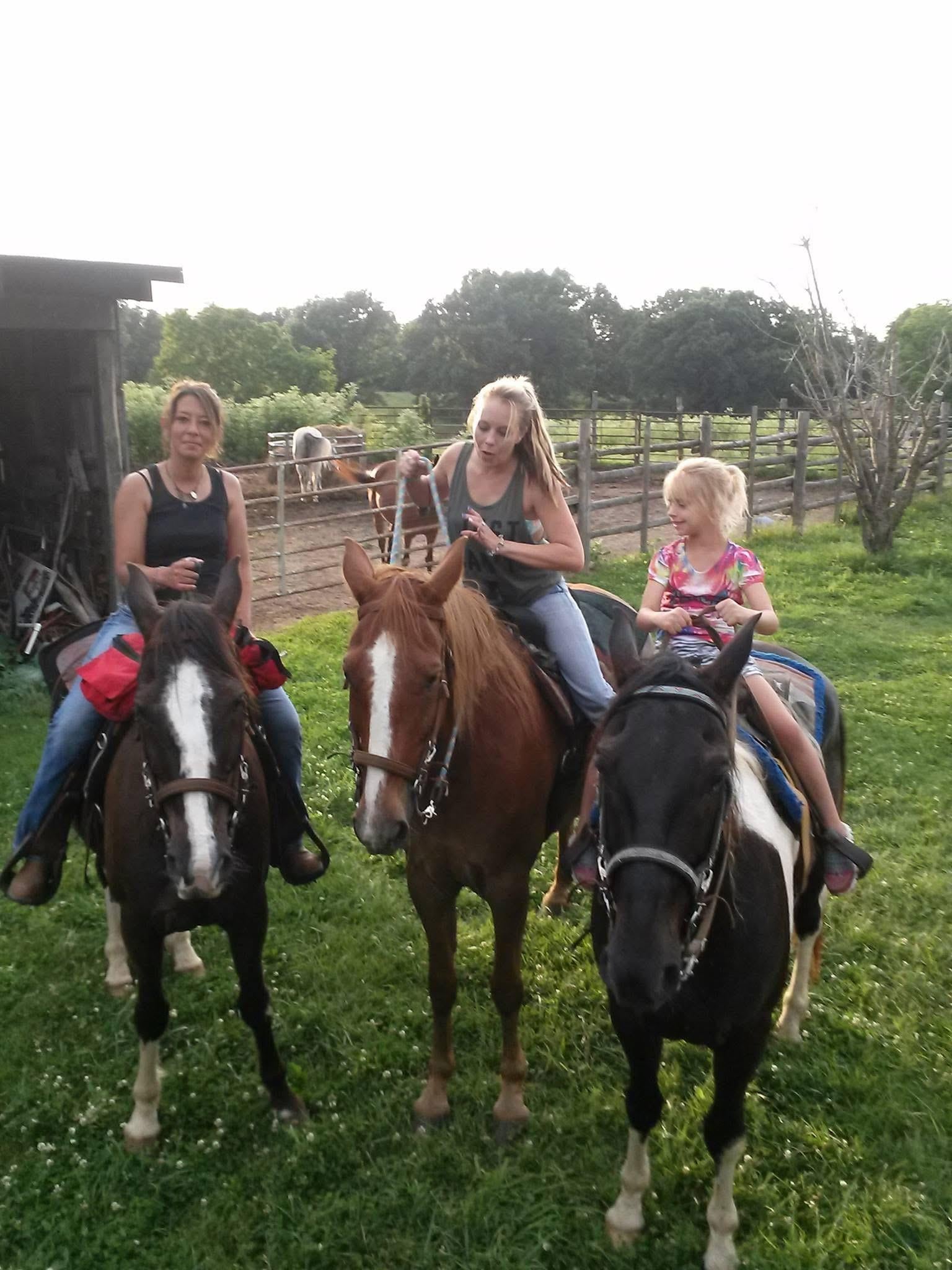 A group of people riding horses