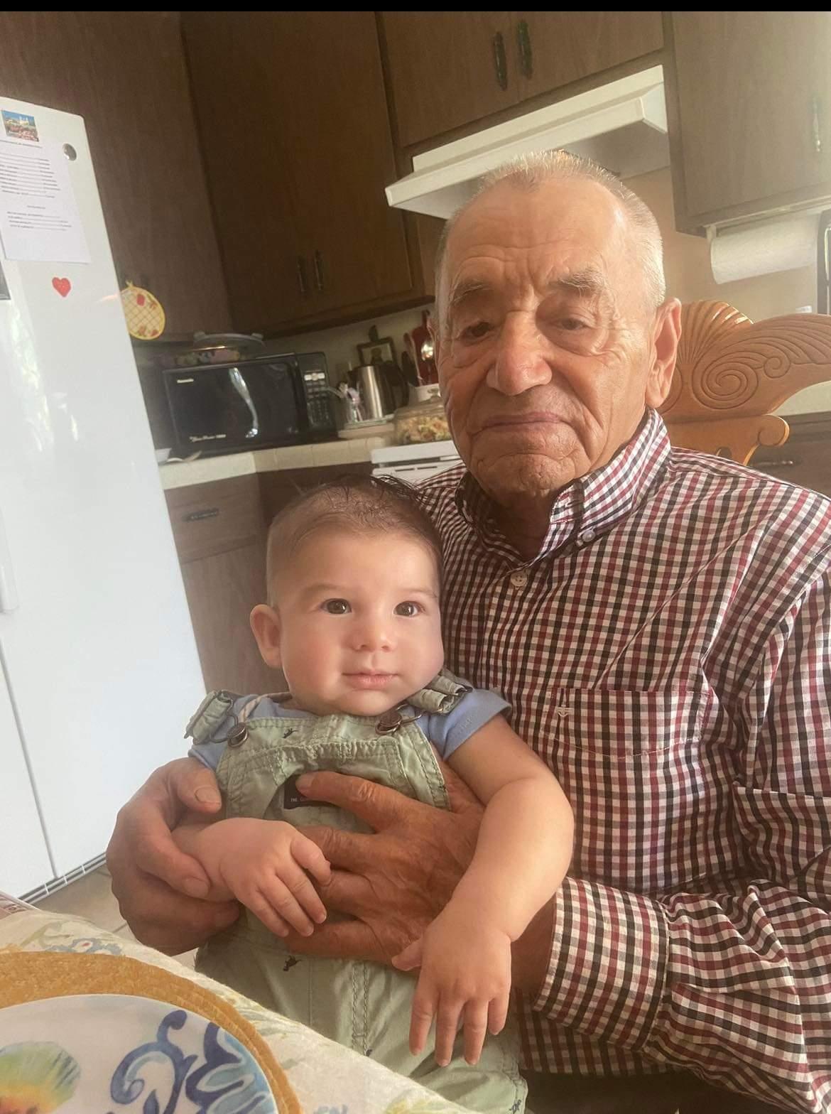 An old man holding a baby