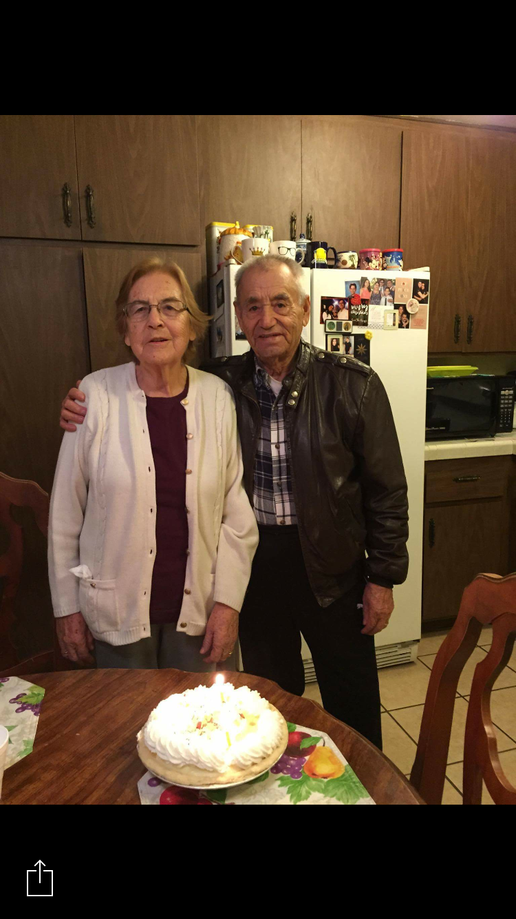 A man and woman standing in front of a cake