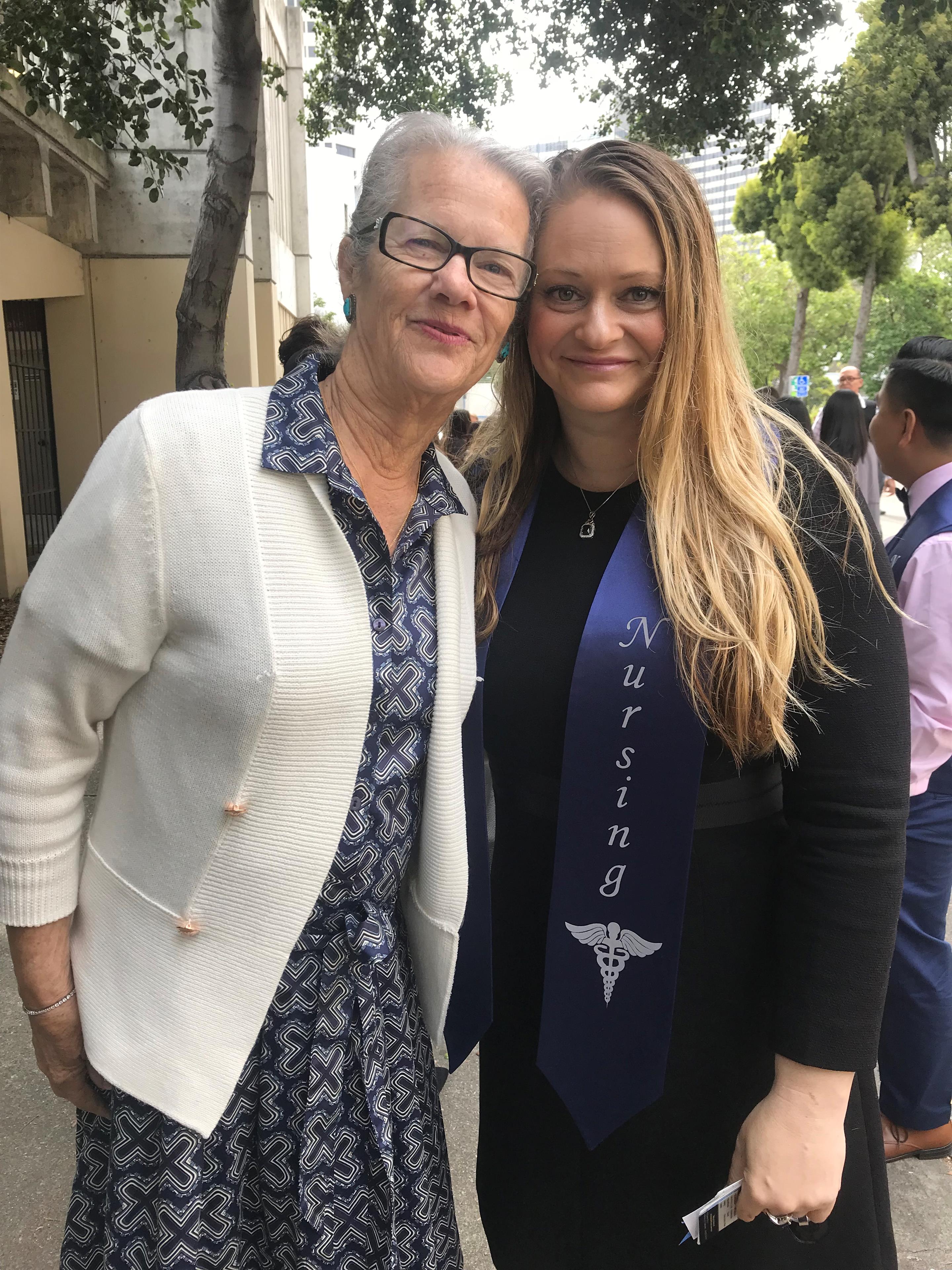 A woman standing next to a woman smiling