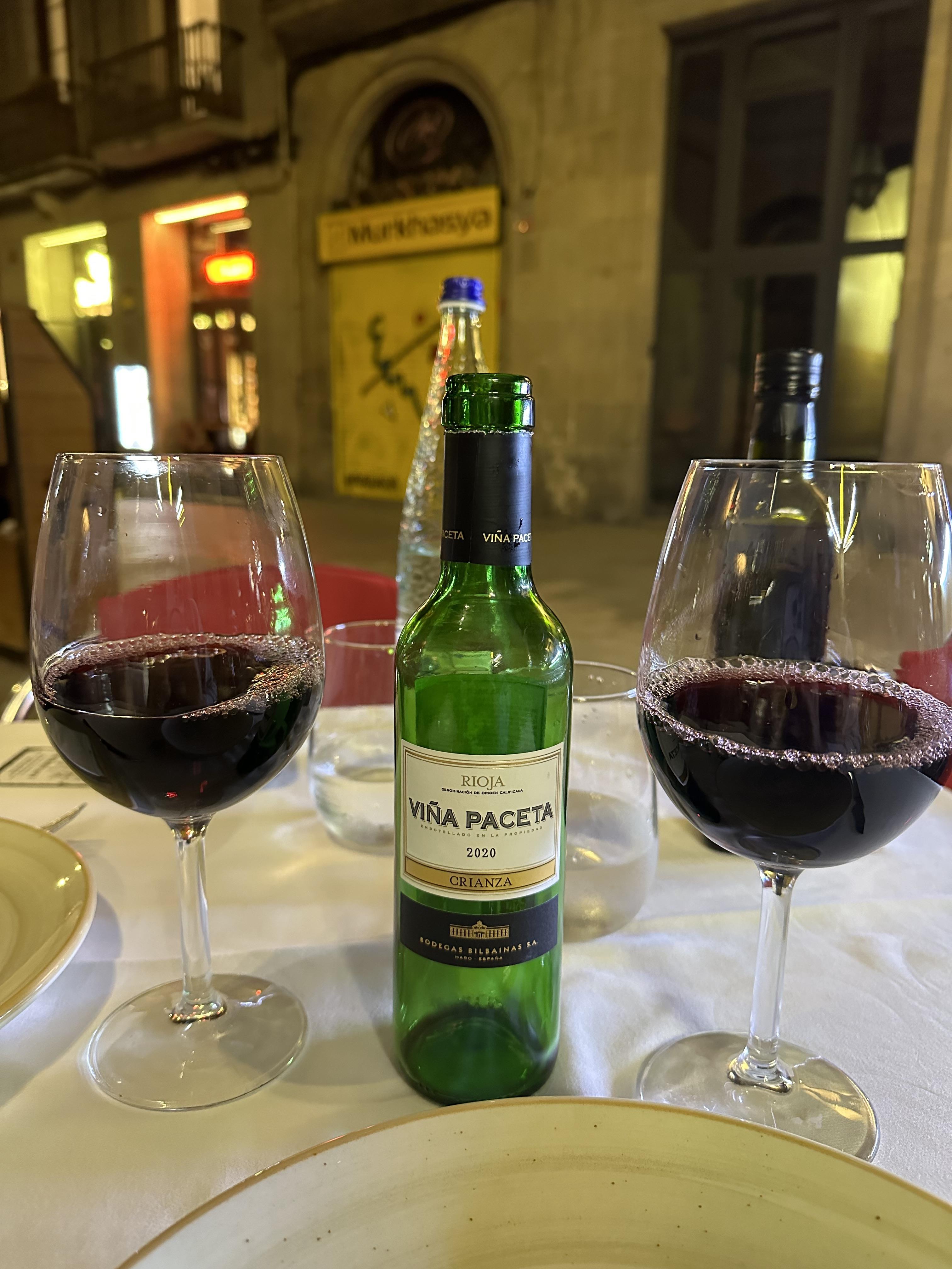 A bottle of wine and two glasses of wine