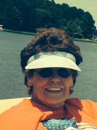 A woman wearing a visor and sunglasses