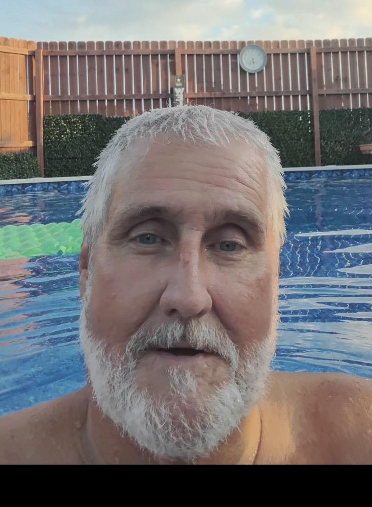 A man with a beard in a pool