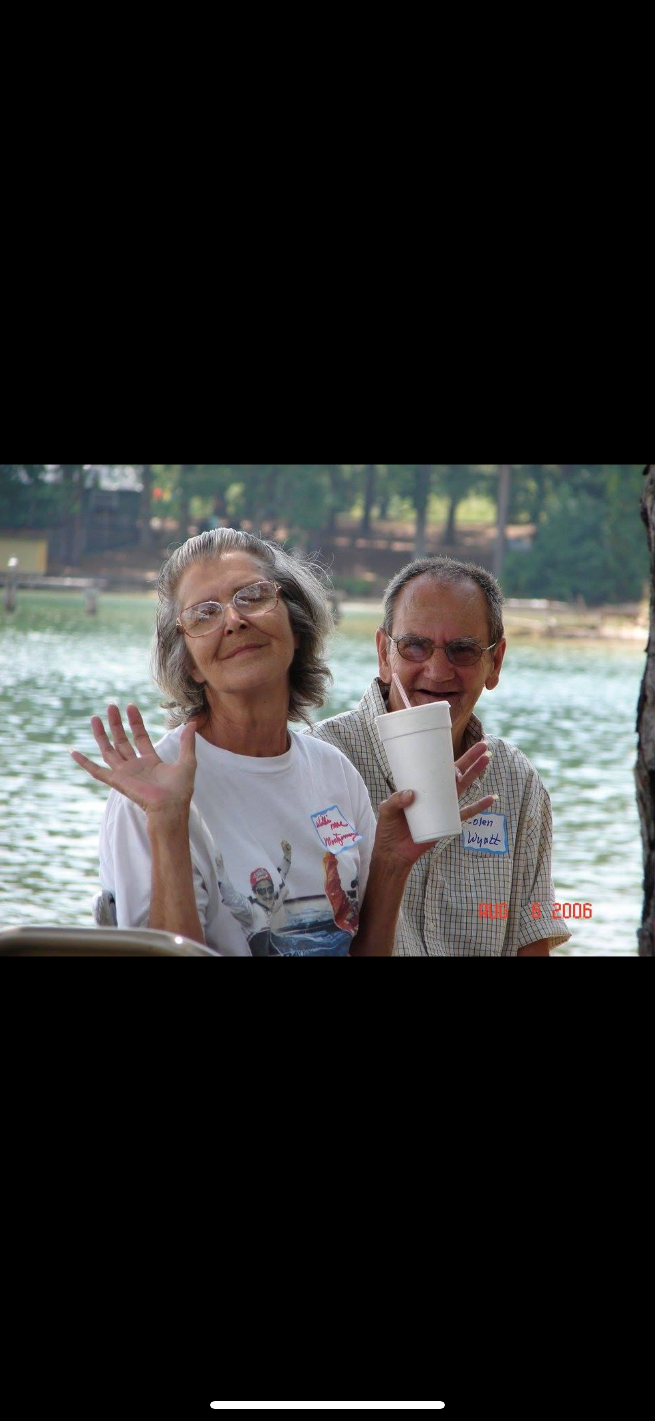 A man and woman holding a cup