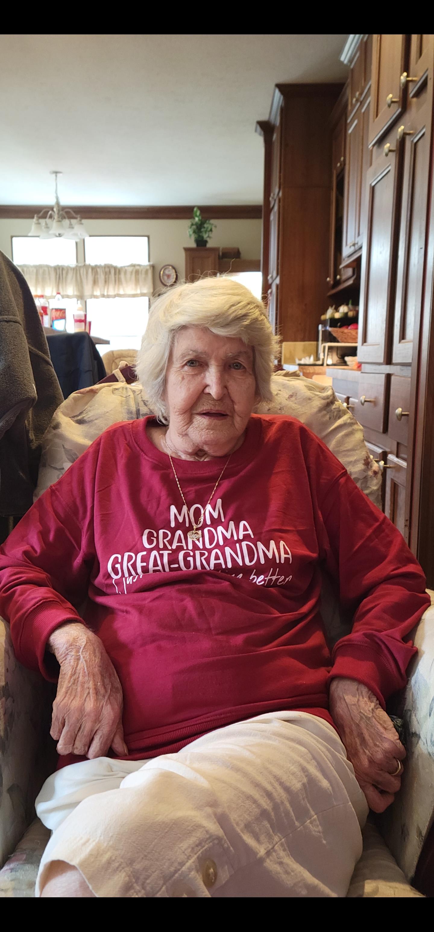 An older woman sitting in a chair