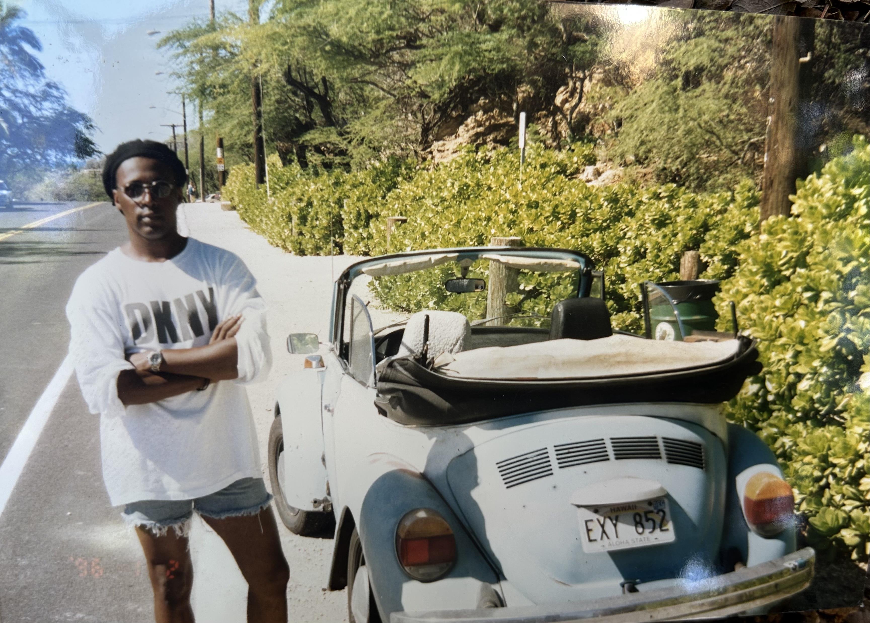 A man standing next to a car