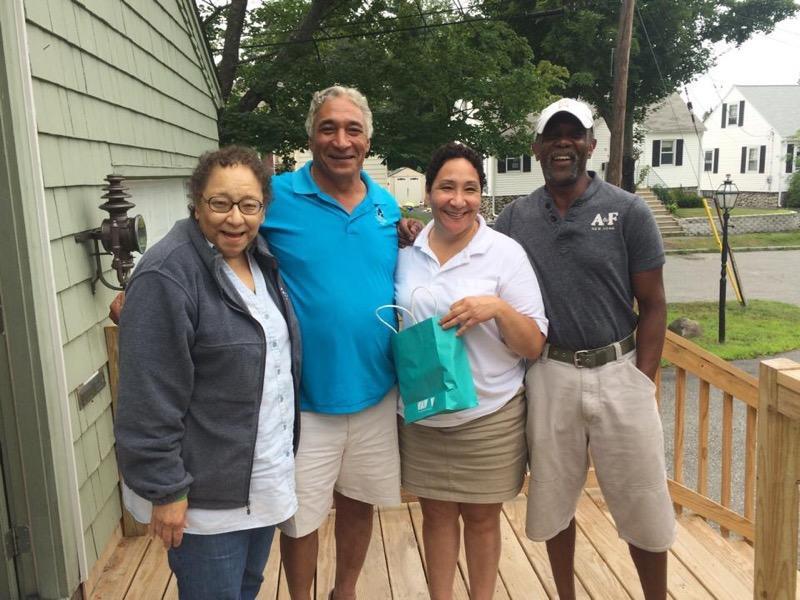 A group of people standing on a porch