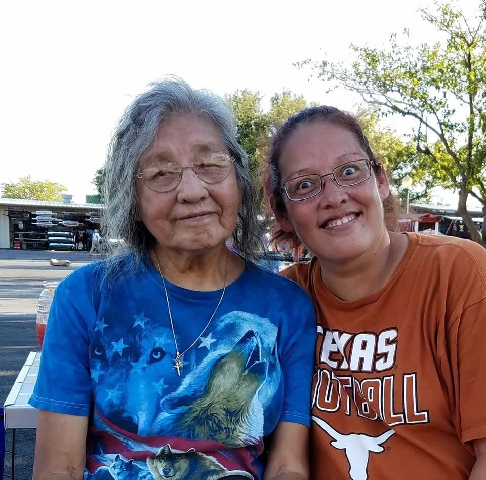 Two women sitting together smiling
