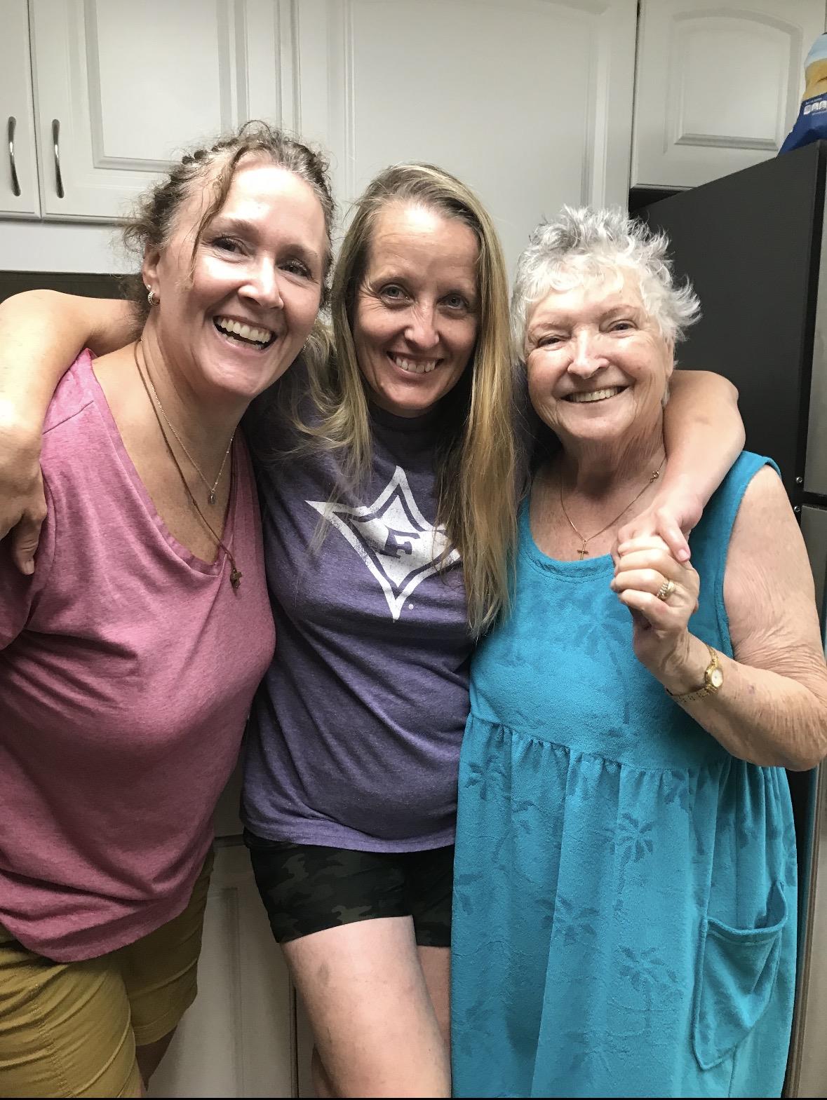 A group of women smiling and hugging