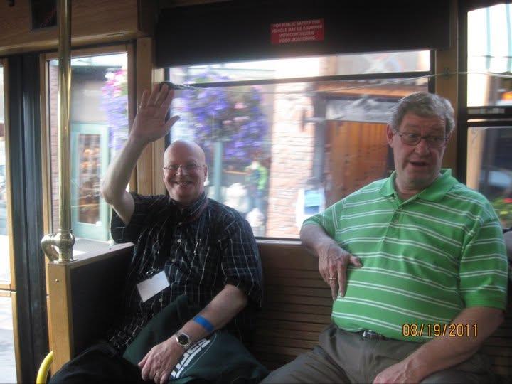A couple of men sitting on a train